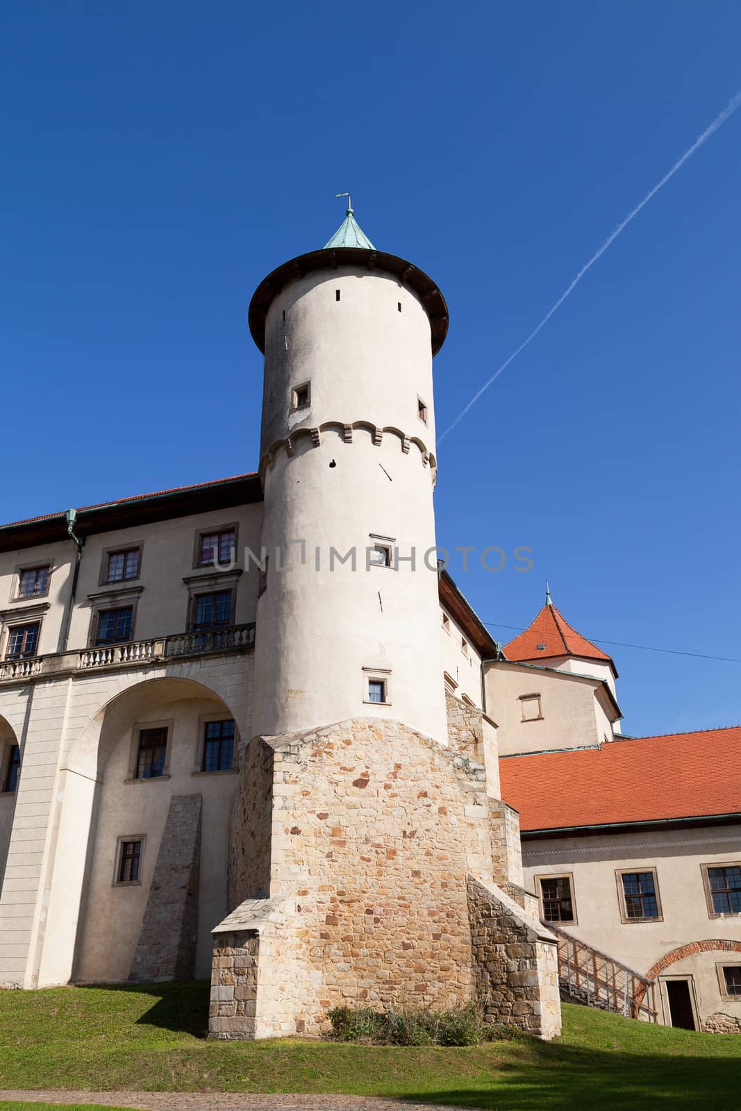 view on castle Nowy Wisnicz in Poland on a background of blue sky