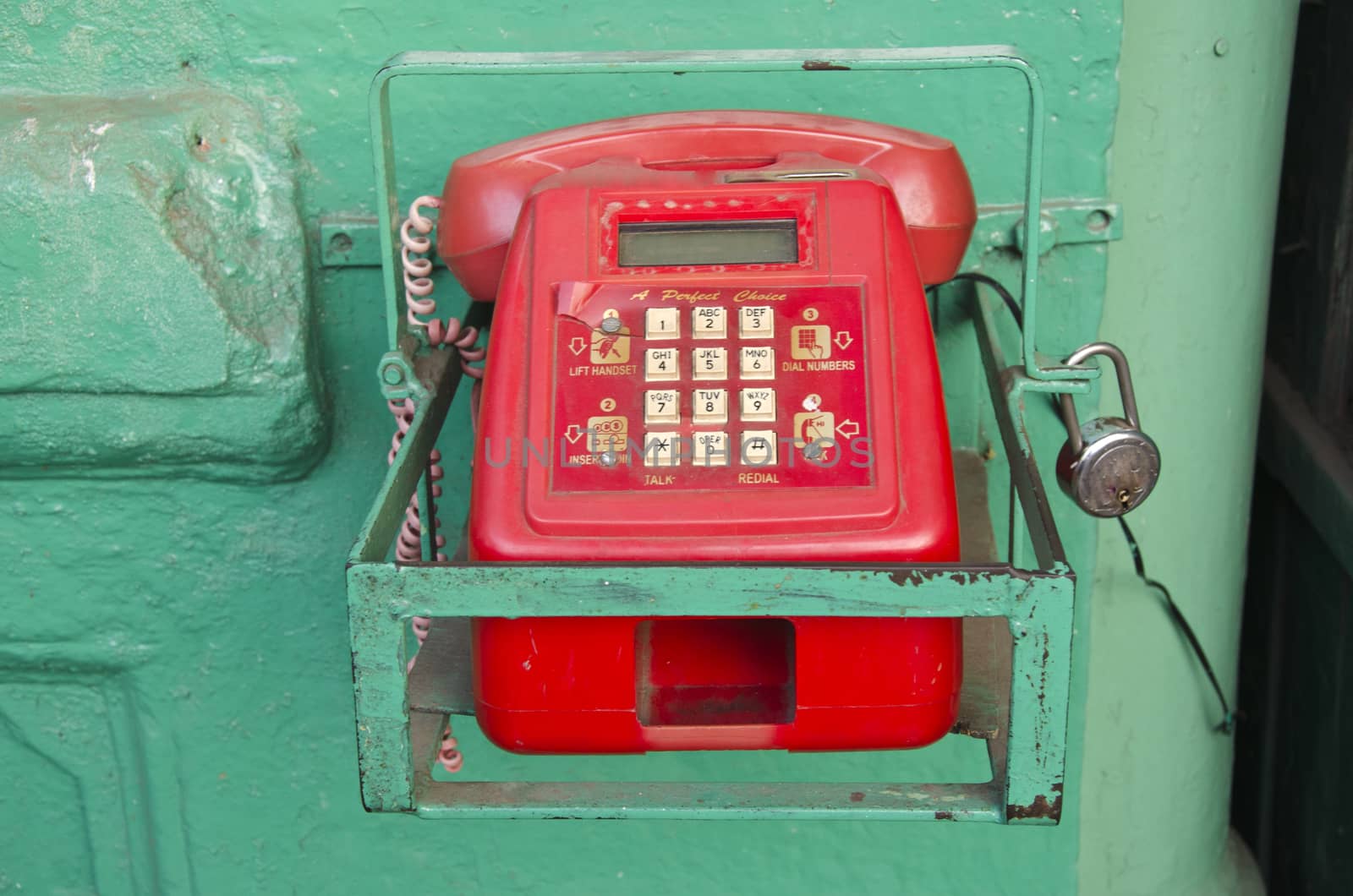 retro red telephone in asia street, India by alis_photo