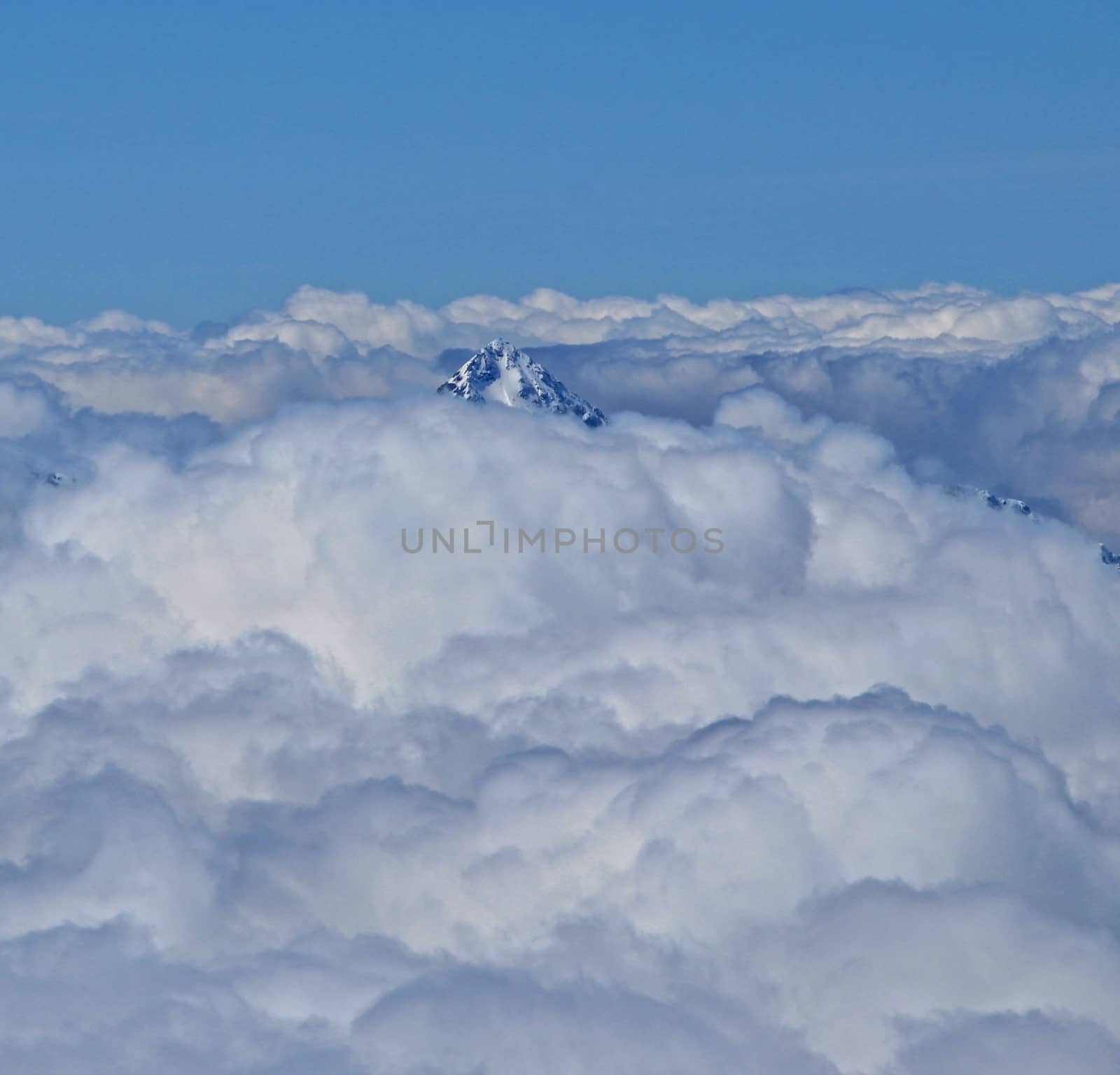 Peak of a 4000m Swiss mountain visable through the clouds