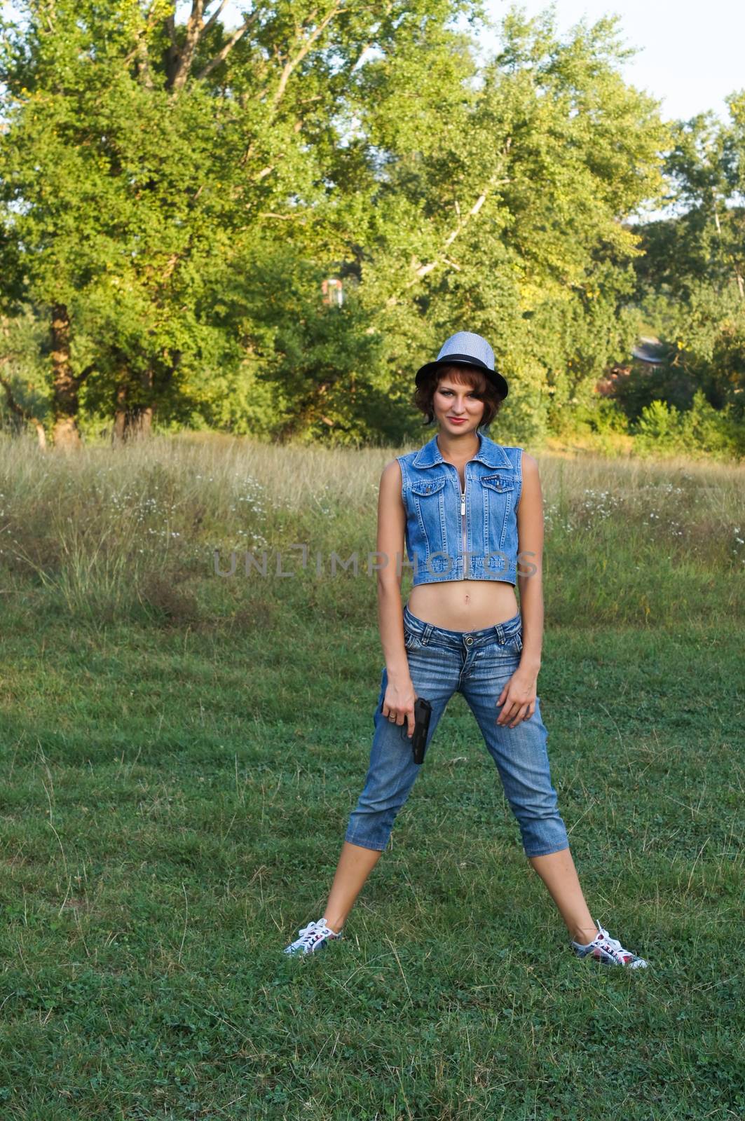 The girl in a hat with a pistol