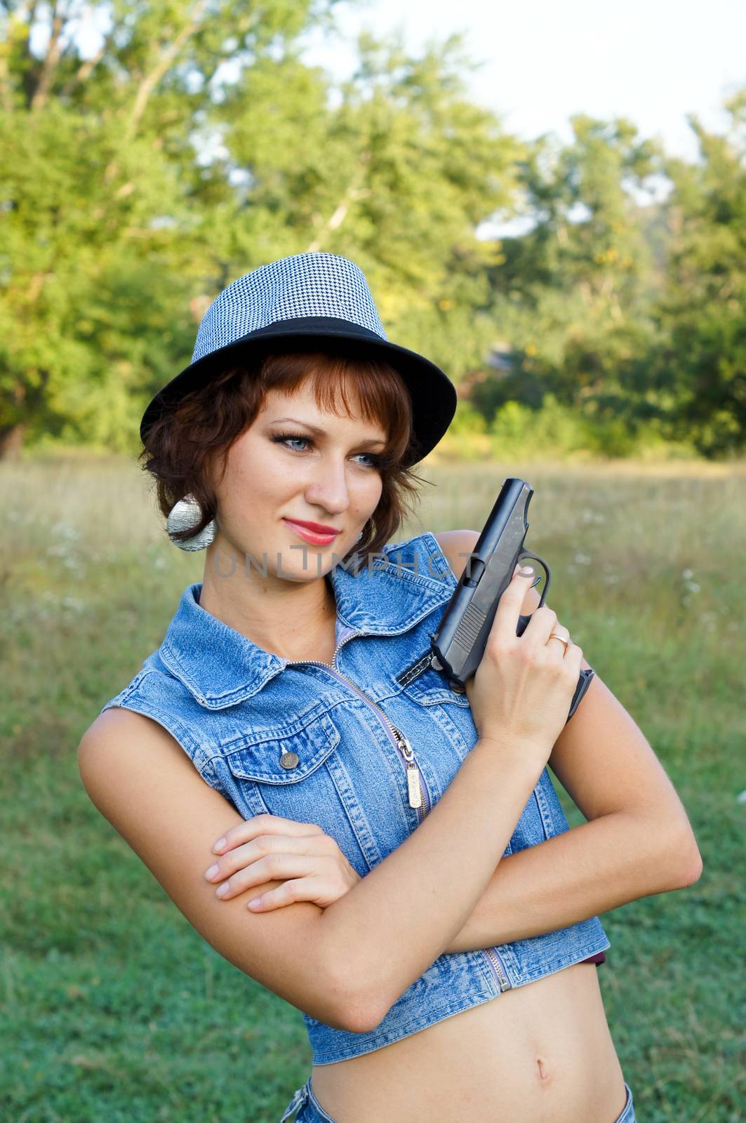 The girl in a hat with a pistol