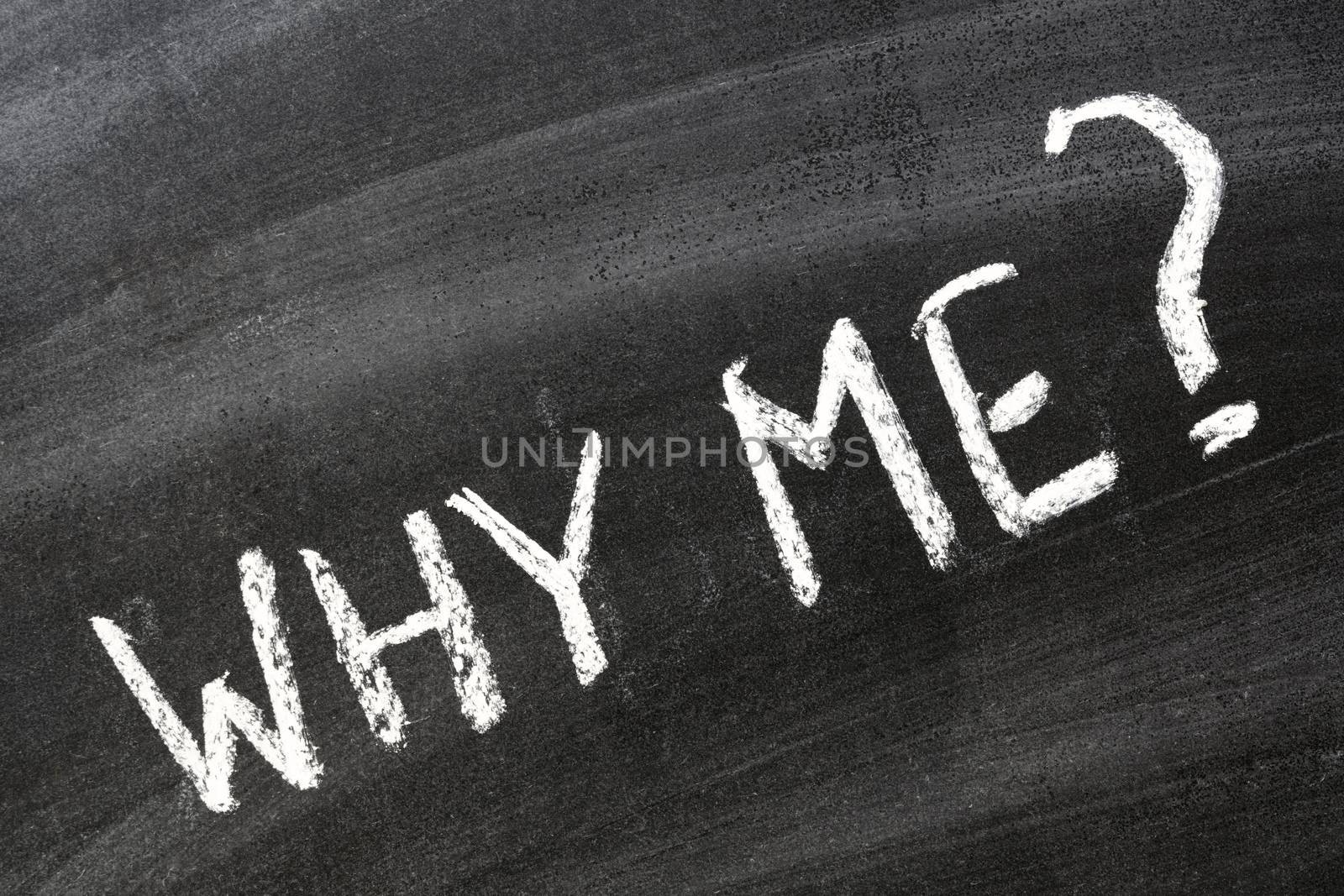 Why me? Question handwritten on school blackboard