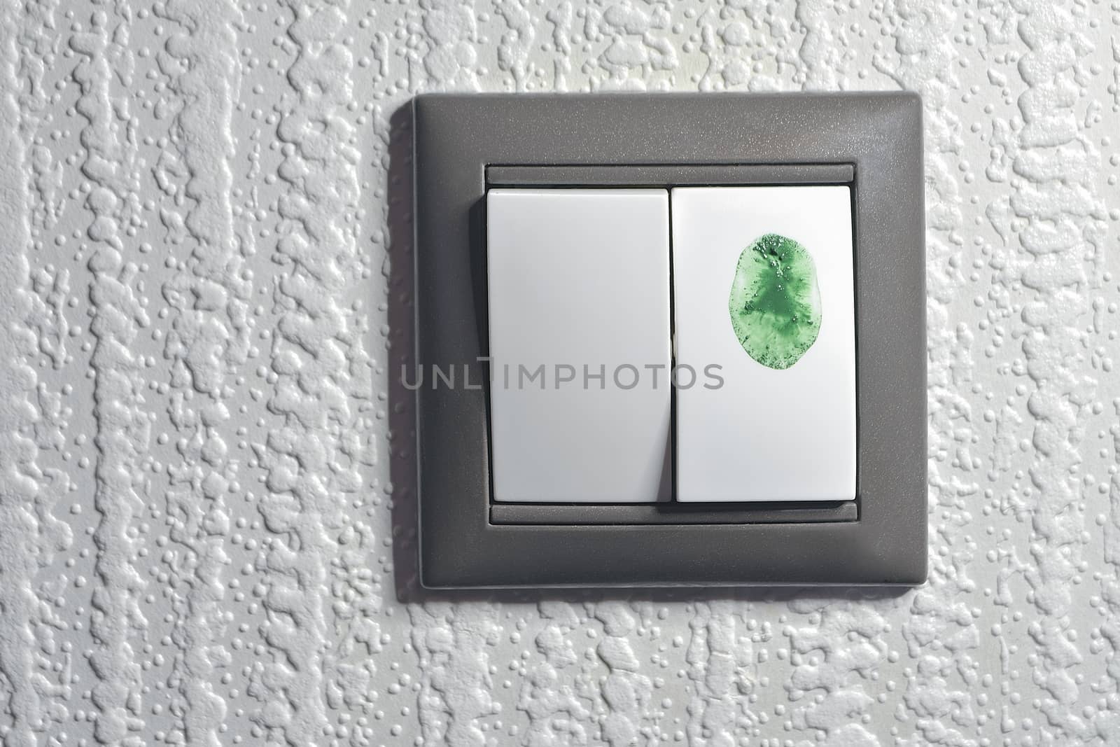 two keys light switch, one is touched by green color fingertip to switch "green" ecological energy