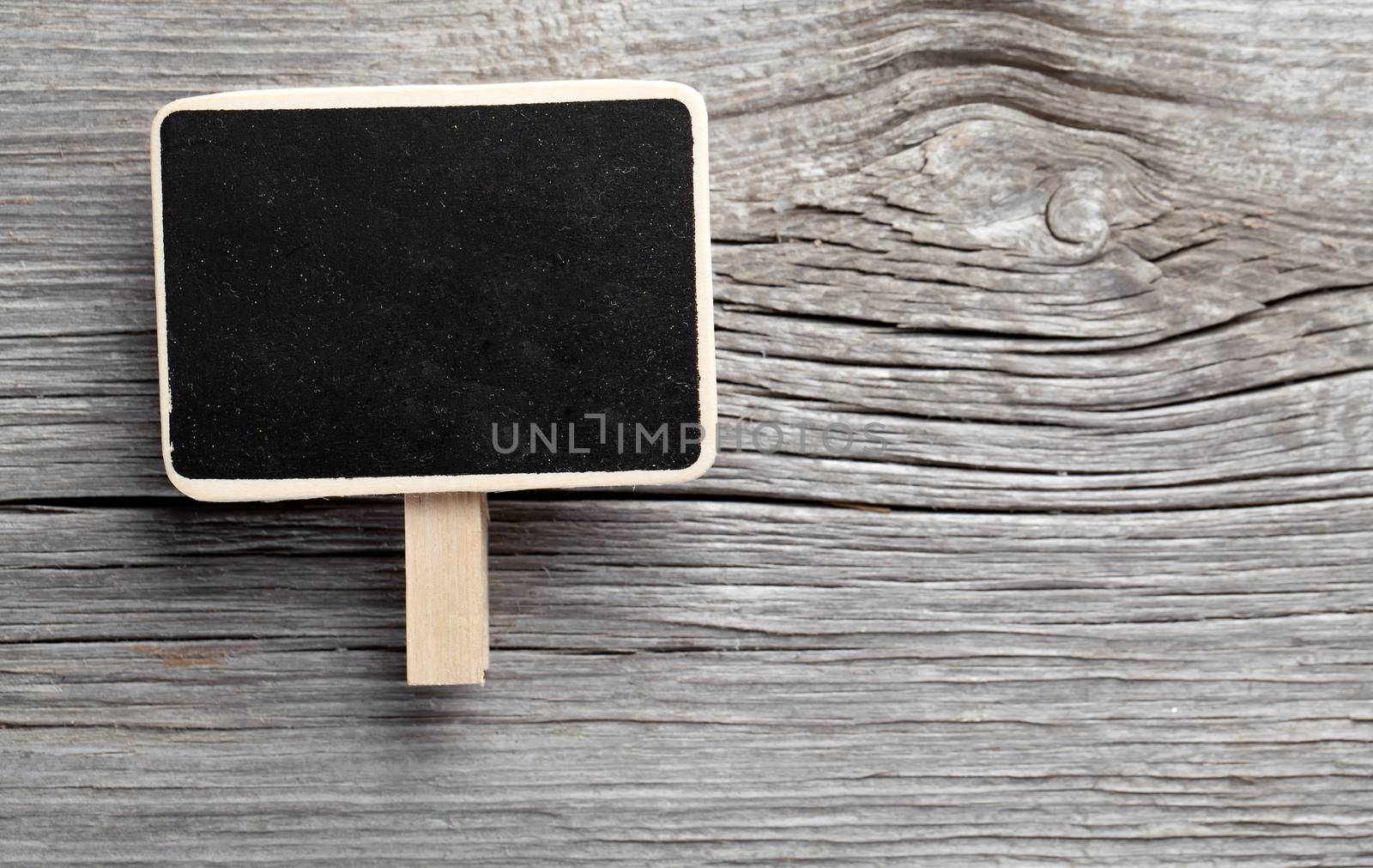 Vintage slate chalk board hanging on wooden background