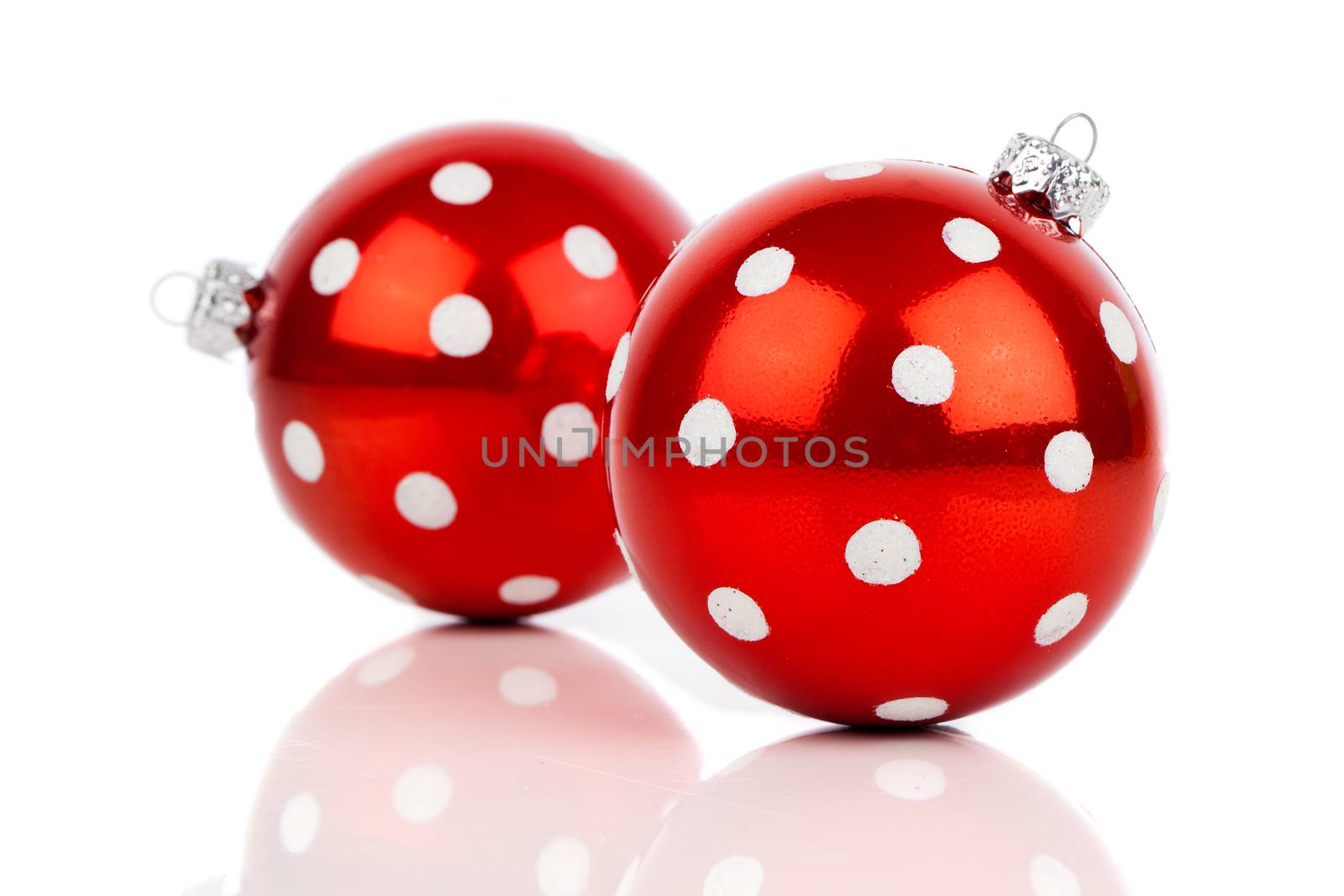 red polka dot Christmas bauble, isolated over white