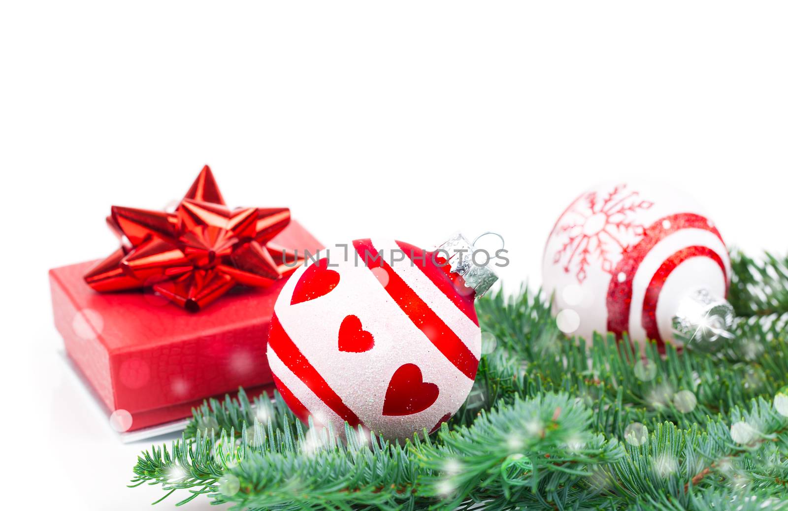 Christmas balls and fir branches with decorations isolated over white