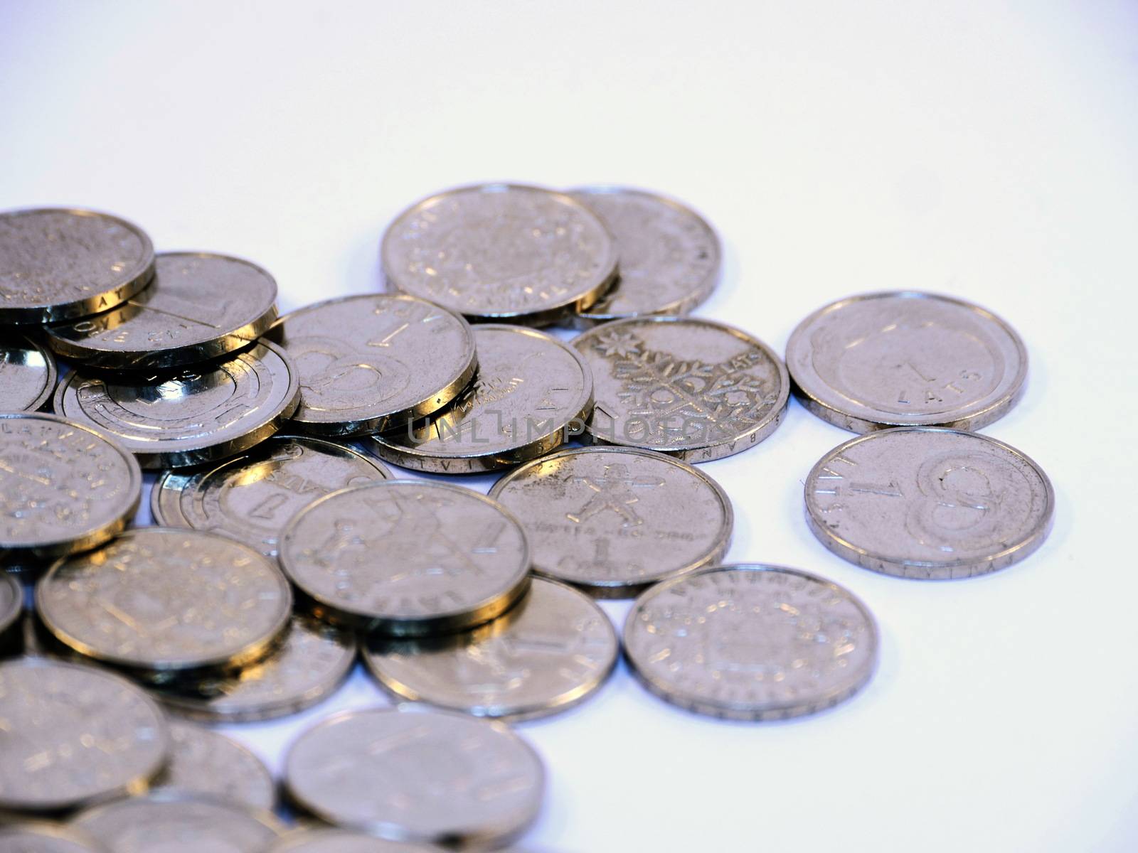 Bunch of Latvian lat coins on white background