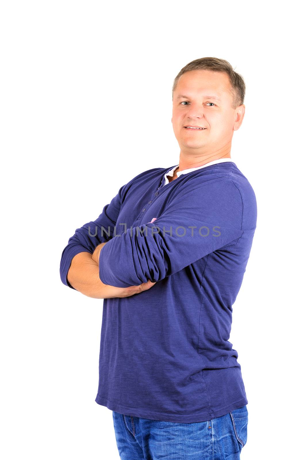 Casually dressed middle aged man with arms folded. 3/4 view of man shot in vertical format isolated on white.