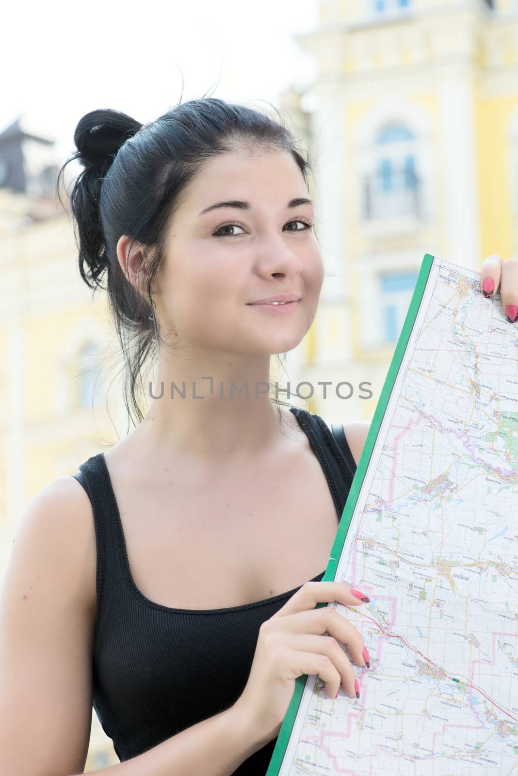 Smiling beautiful woman with map in hands
