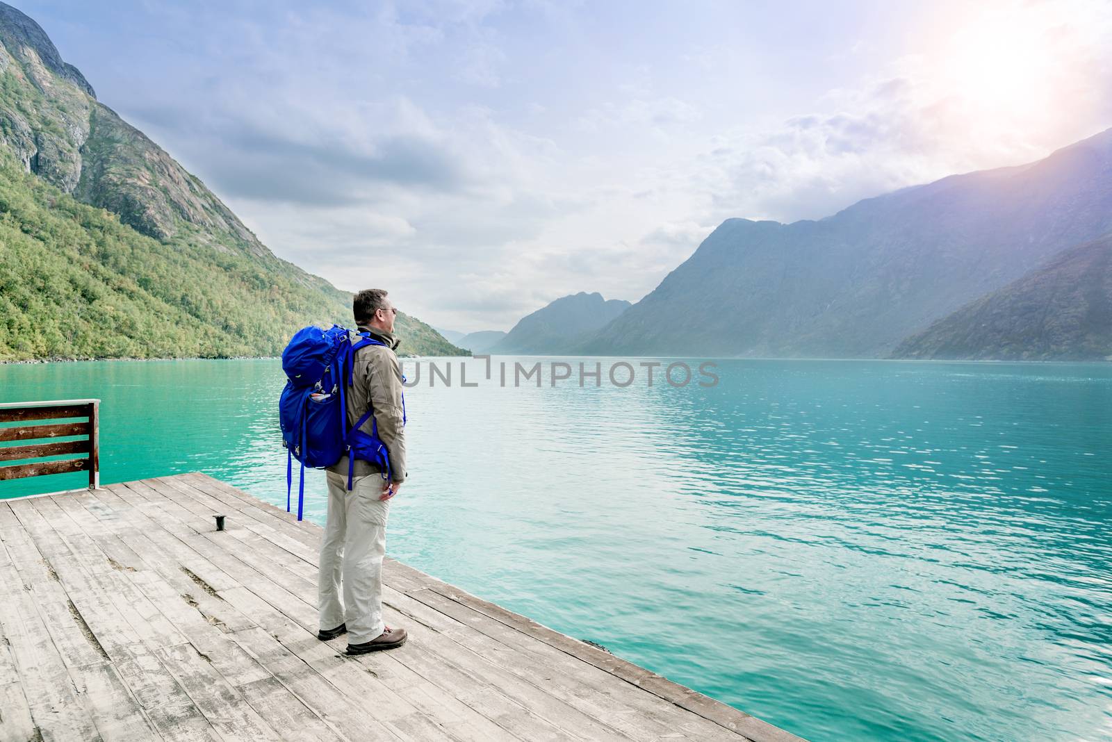 Lone traveler looking at fjord