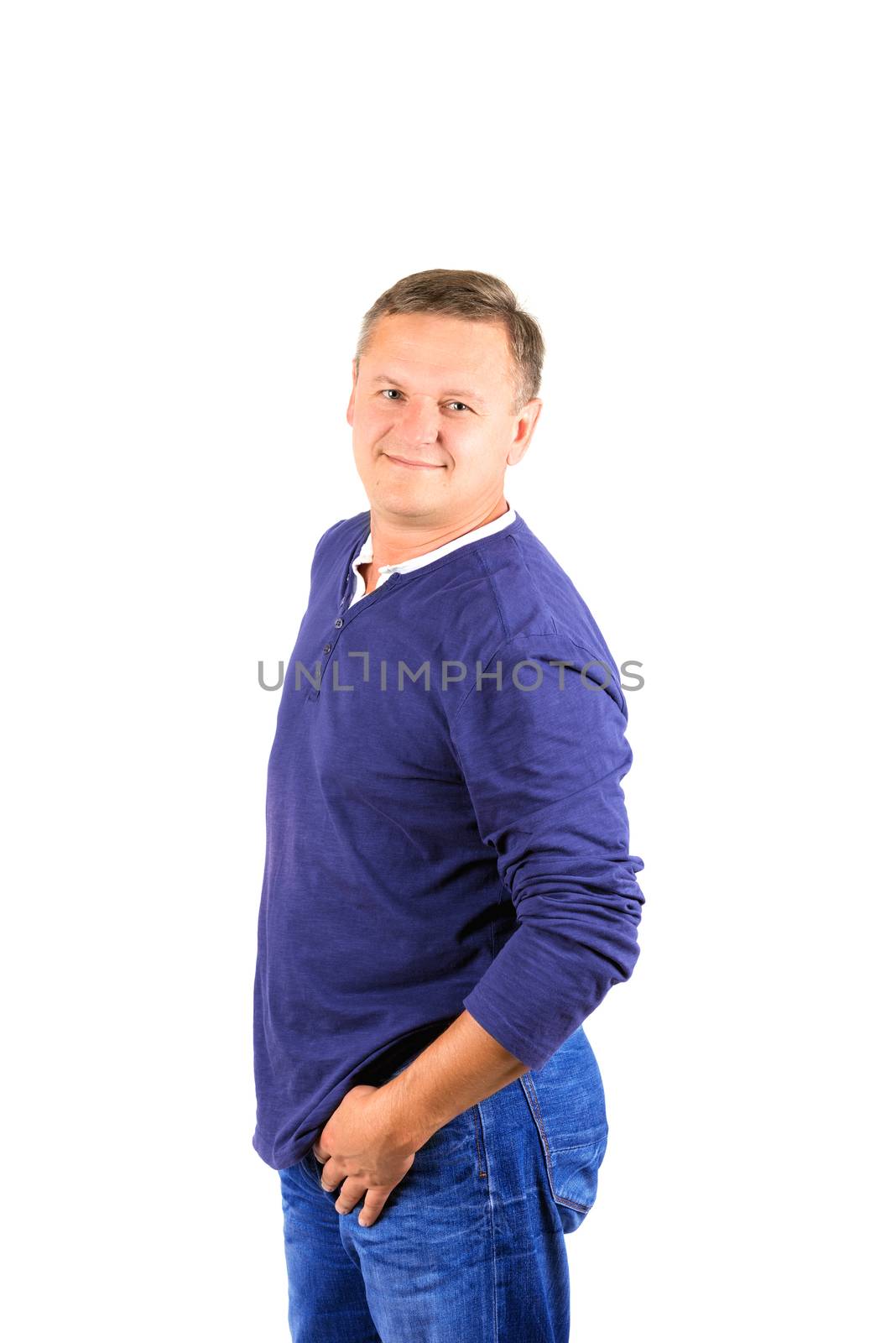 Casually dressed middle aged man smiling. 3/4 view of man shot in vertical format isolated on white.