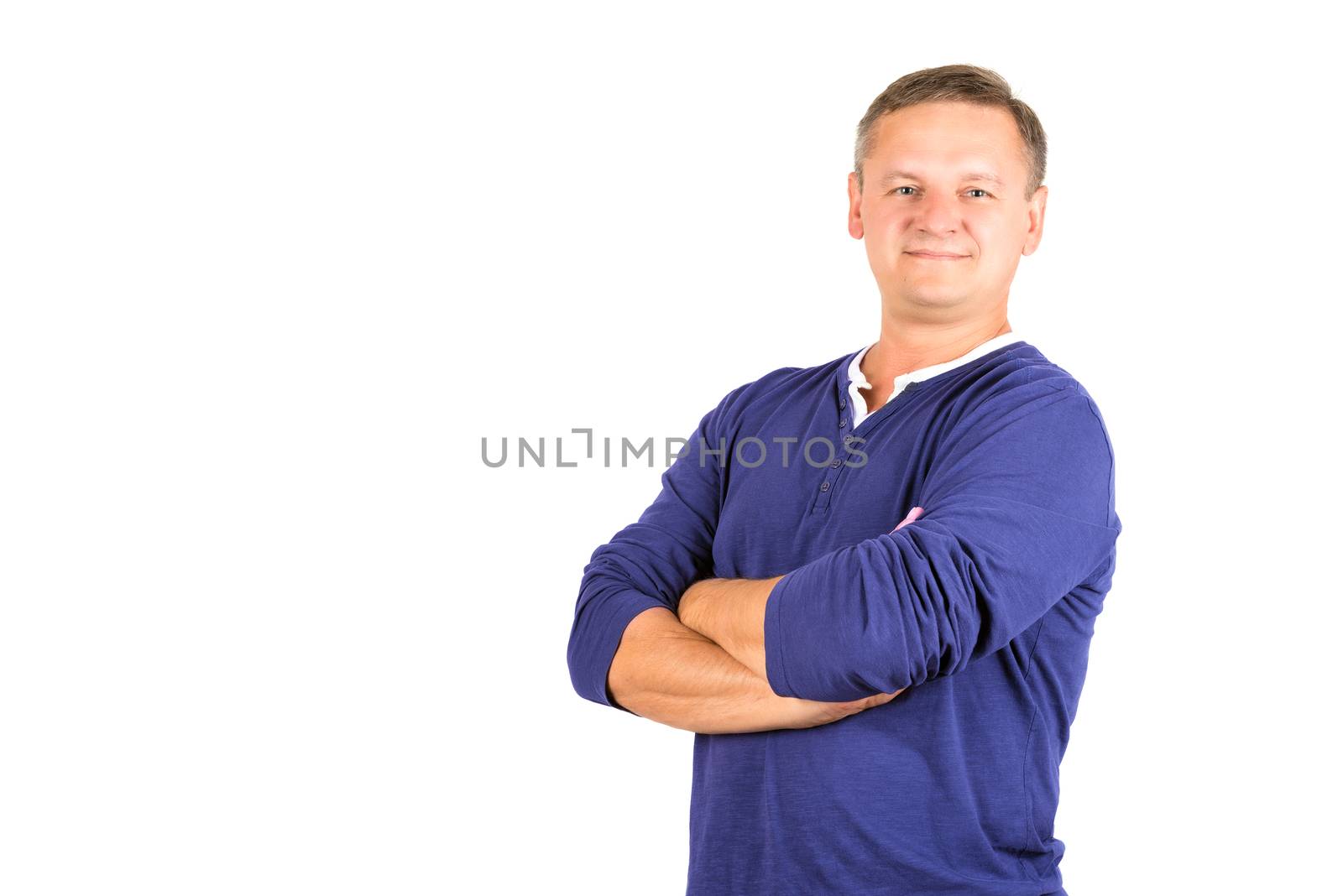 Casually dressed middle aged man with arms folded. 3/4 view of man shot in horizontal format isolated on white.