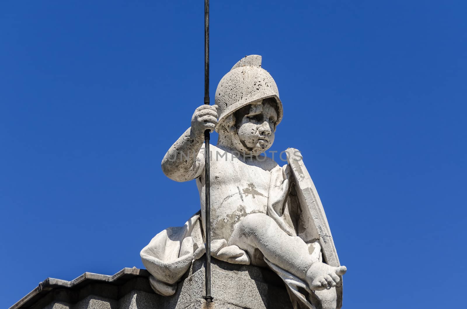 Statue of a boy on top of building in Spain