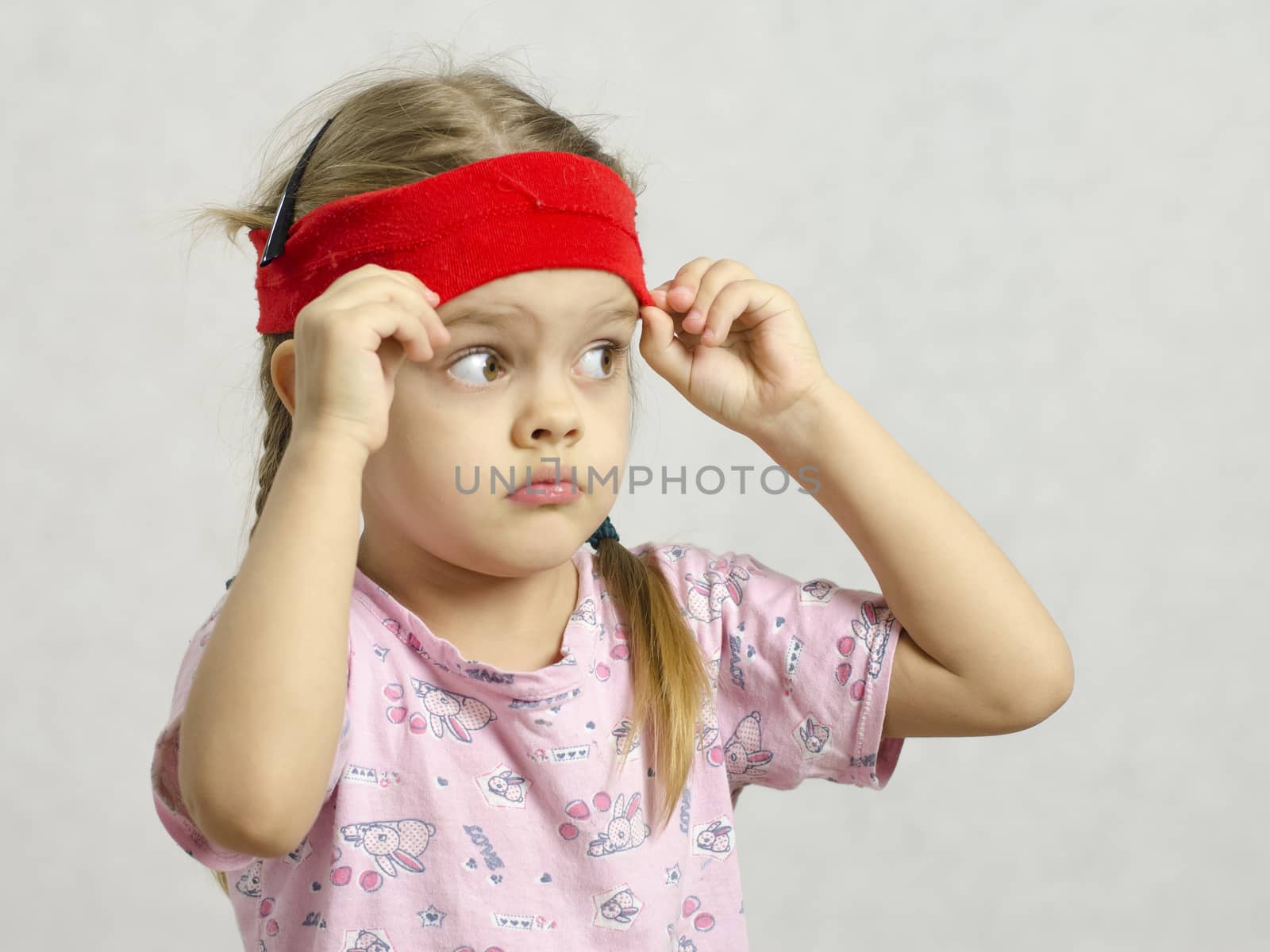 Girl with a bandage on his head stares right. Trying to cover his eyes bandaged. Big eyes.