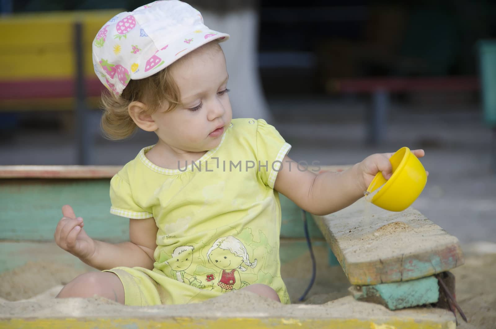  Little girl playing in the sandbox by Madhourse