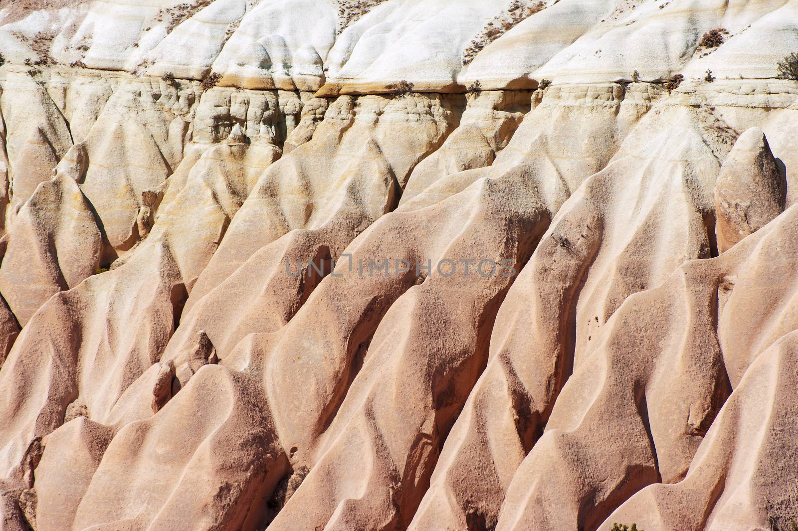 Detailed photo of vivid pink rock formations from above in Cappadocia, Turkey