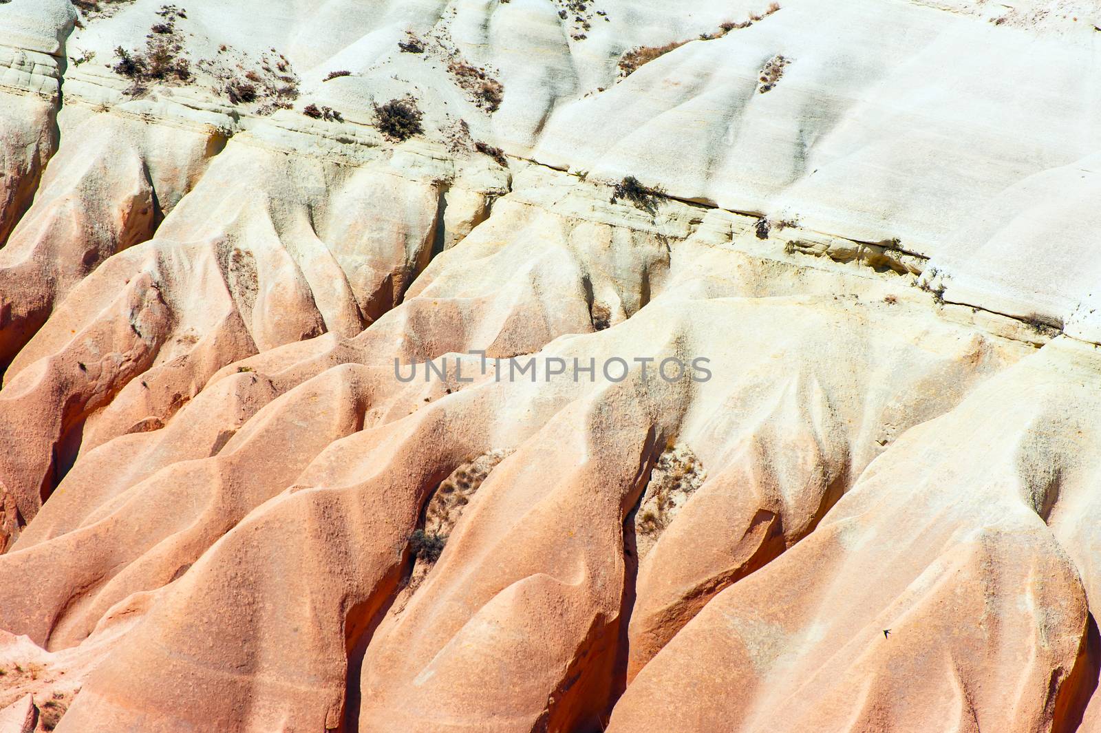 Detailed photo of vivid pink rock formations from above in Cappadocia, Turkey