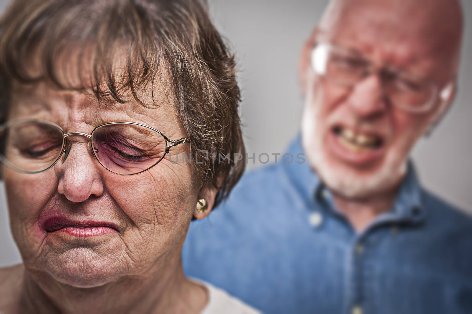 Battered and Scared Woman with Ominous Man Behind by Feverpitched