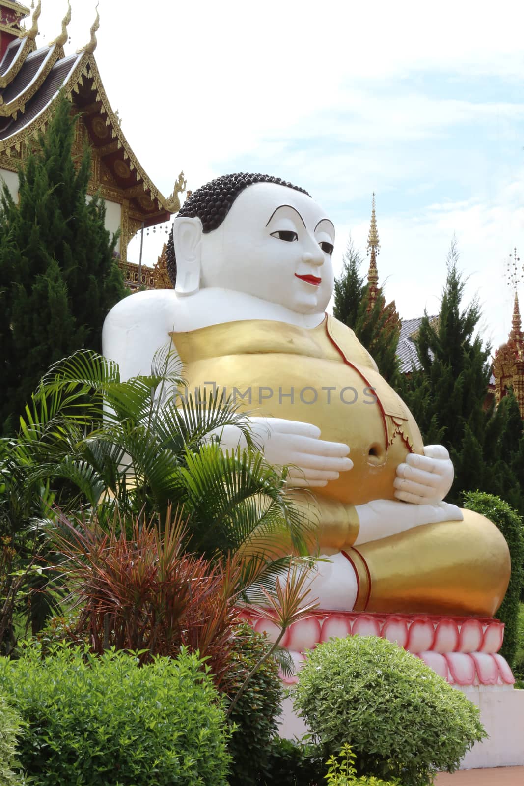 The statue of happy Buddha is located at temple.