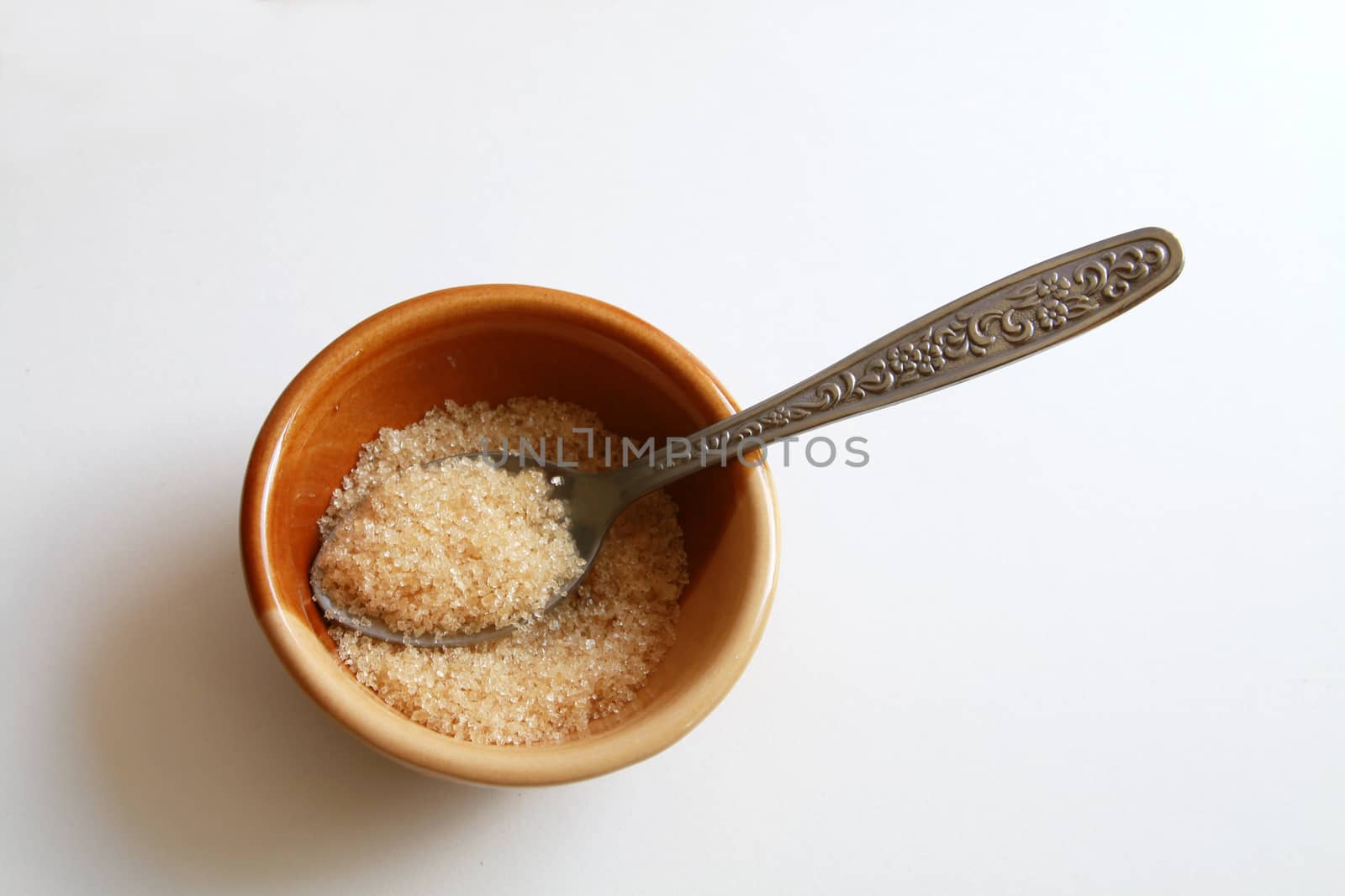 Brown sugar in the bowl and tea spoon.