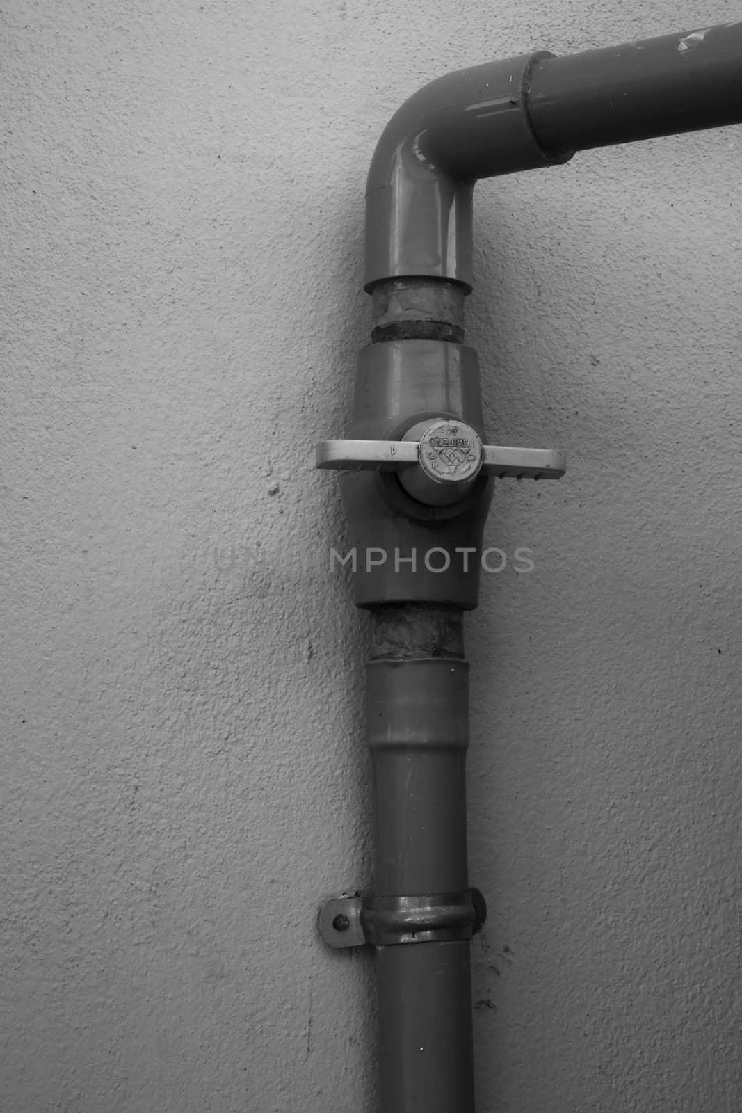 The old water valve mounted on the wall.
