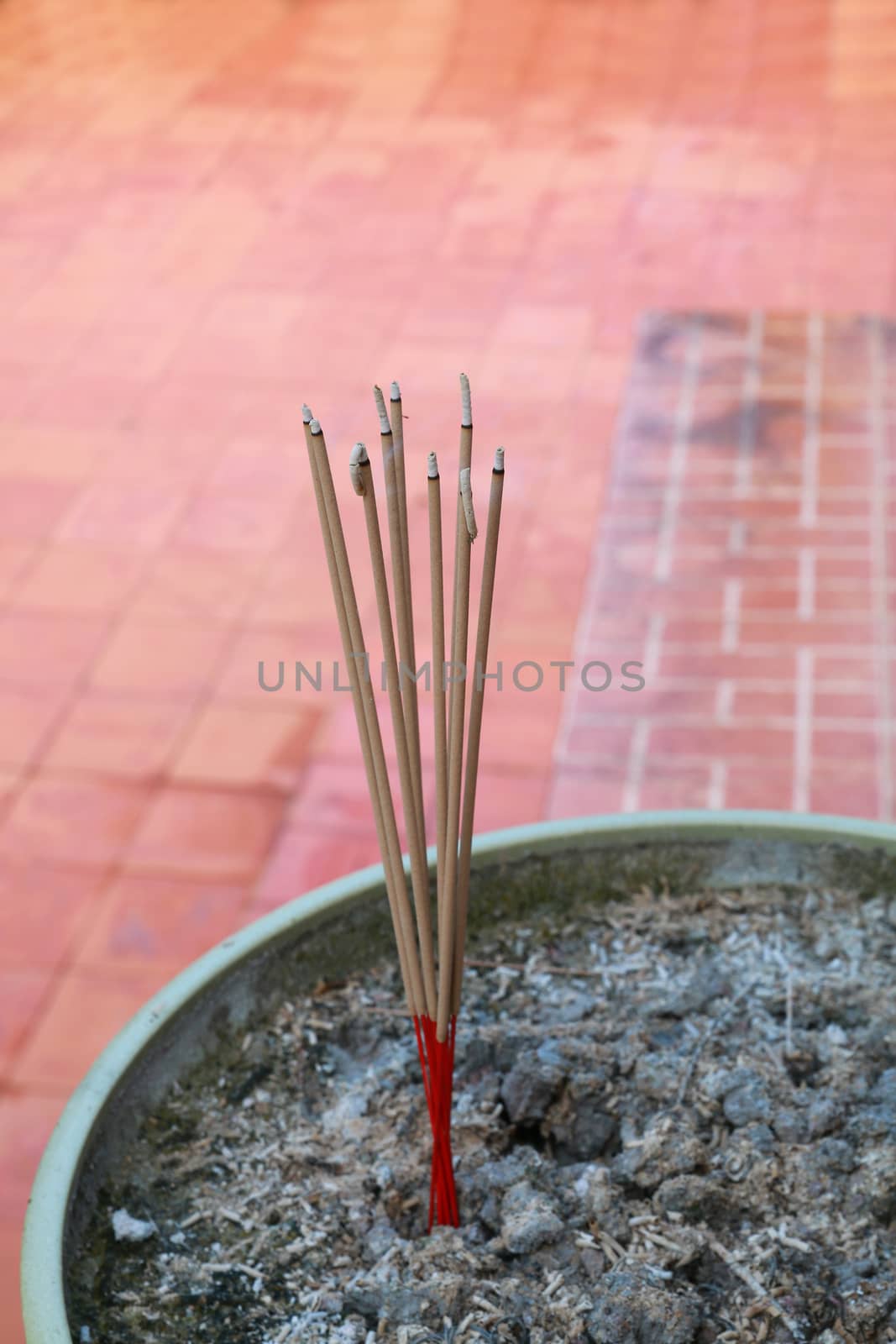 There are joss sticks  burning in the incense burner.