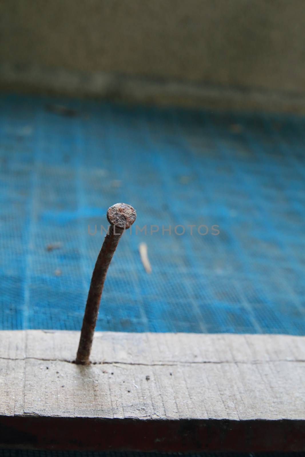 The rusty nail stamping on wood.