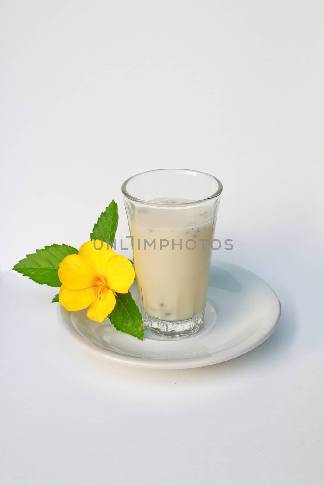 The glass of hot soy milk with lemon basil.