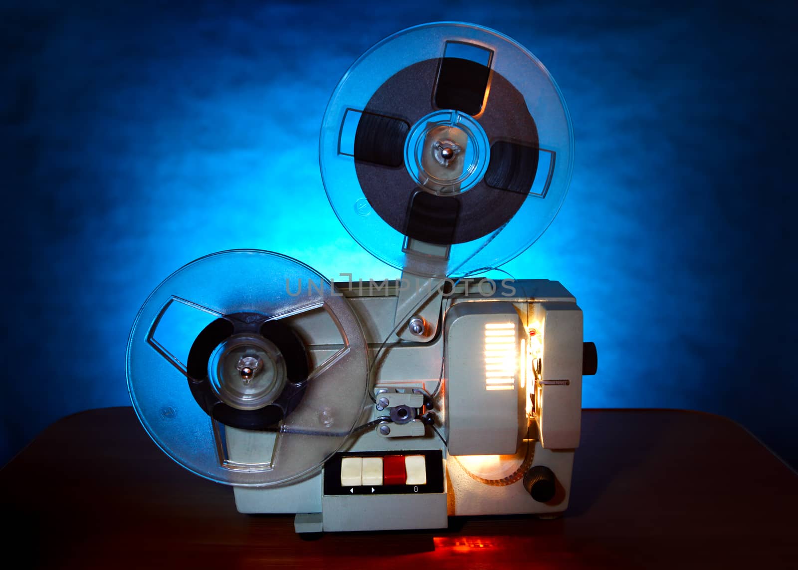 Old 8mm film projector in dusk on the Table