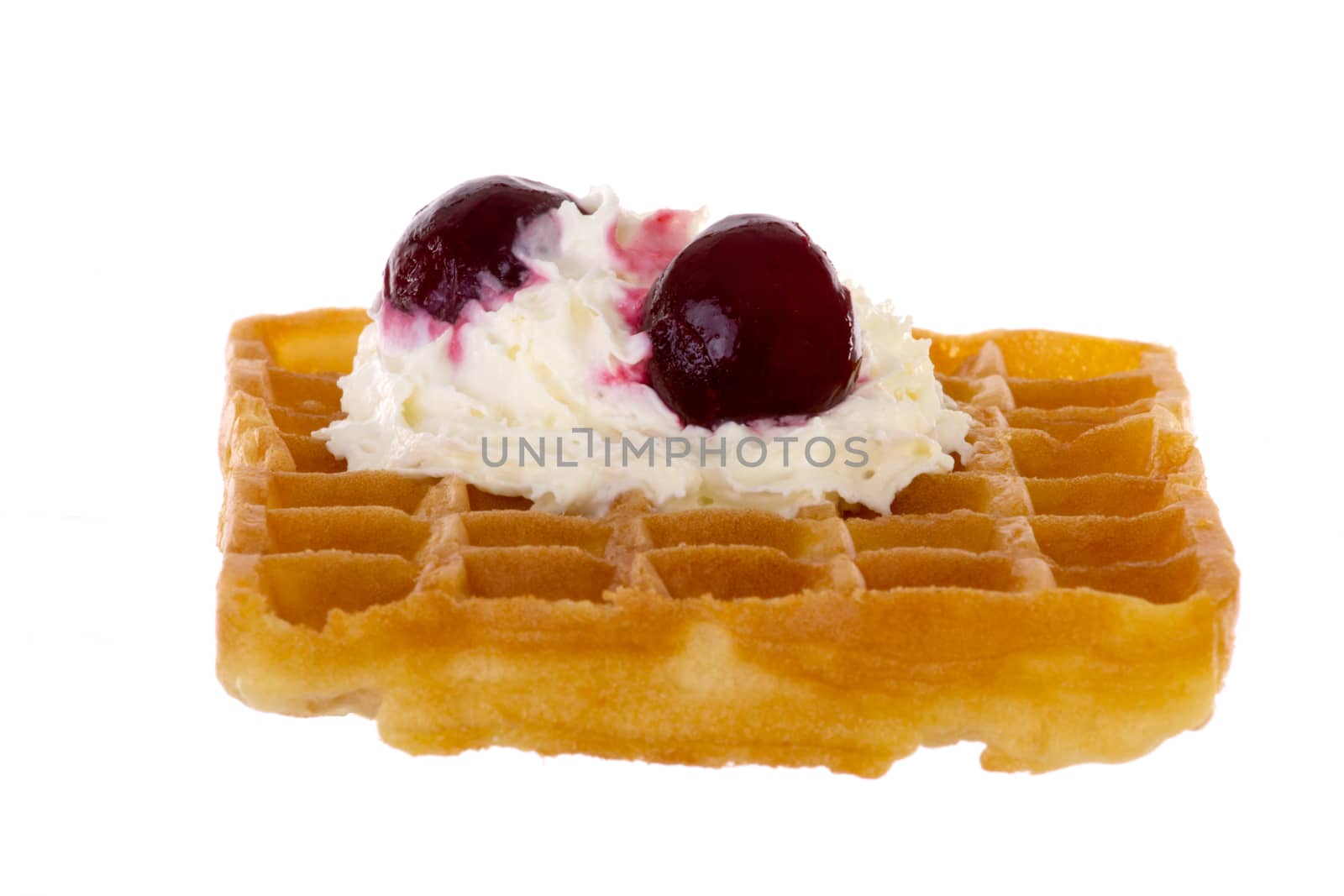Cherries and whipped cream on freshly baked waffle by gwolters