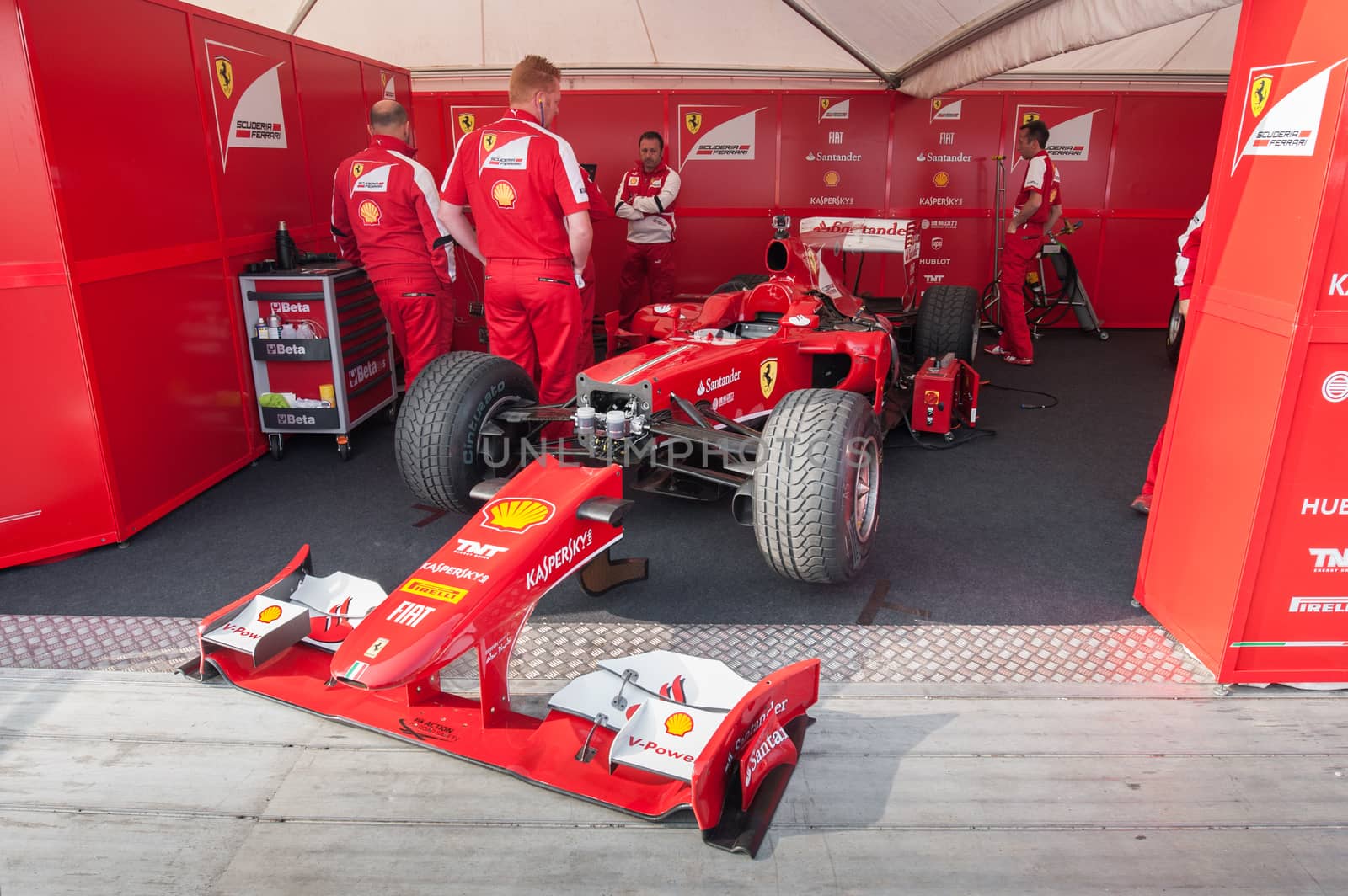 Goodwood, UK - July 13, 2013: Ferrari Formula 1 race car and mechanics at the Festival of Speed event in Goodwood, UK