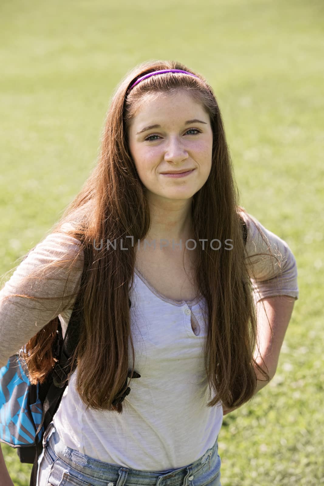 Cute young Caucasian teenage female with backpack