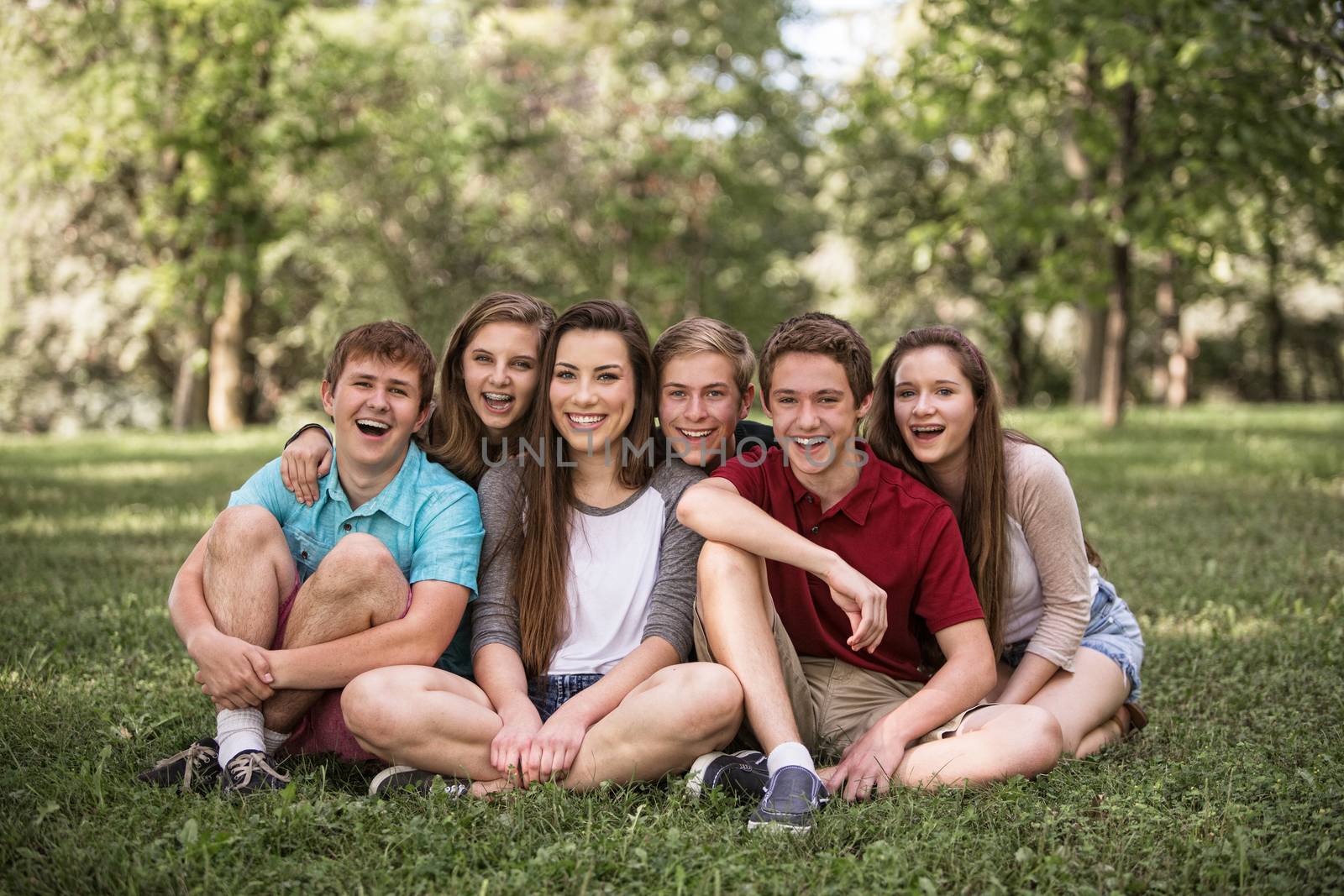 Group of young white people sitting outdoors