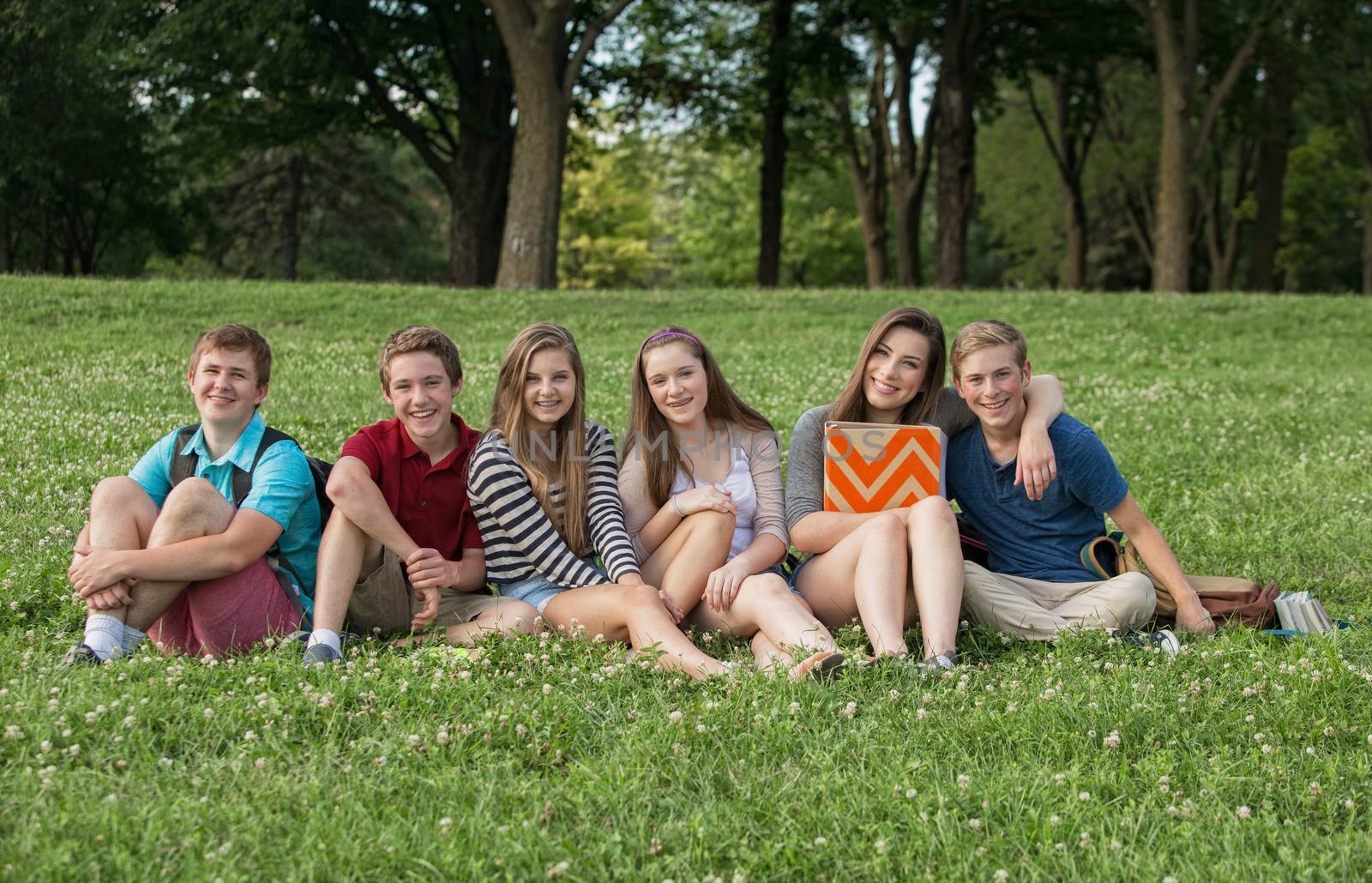 Attractive group of Caucasian teen students outdoors