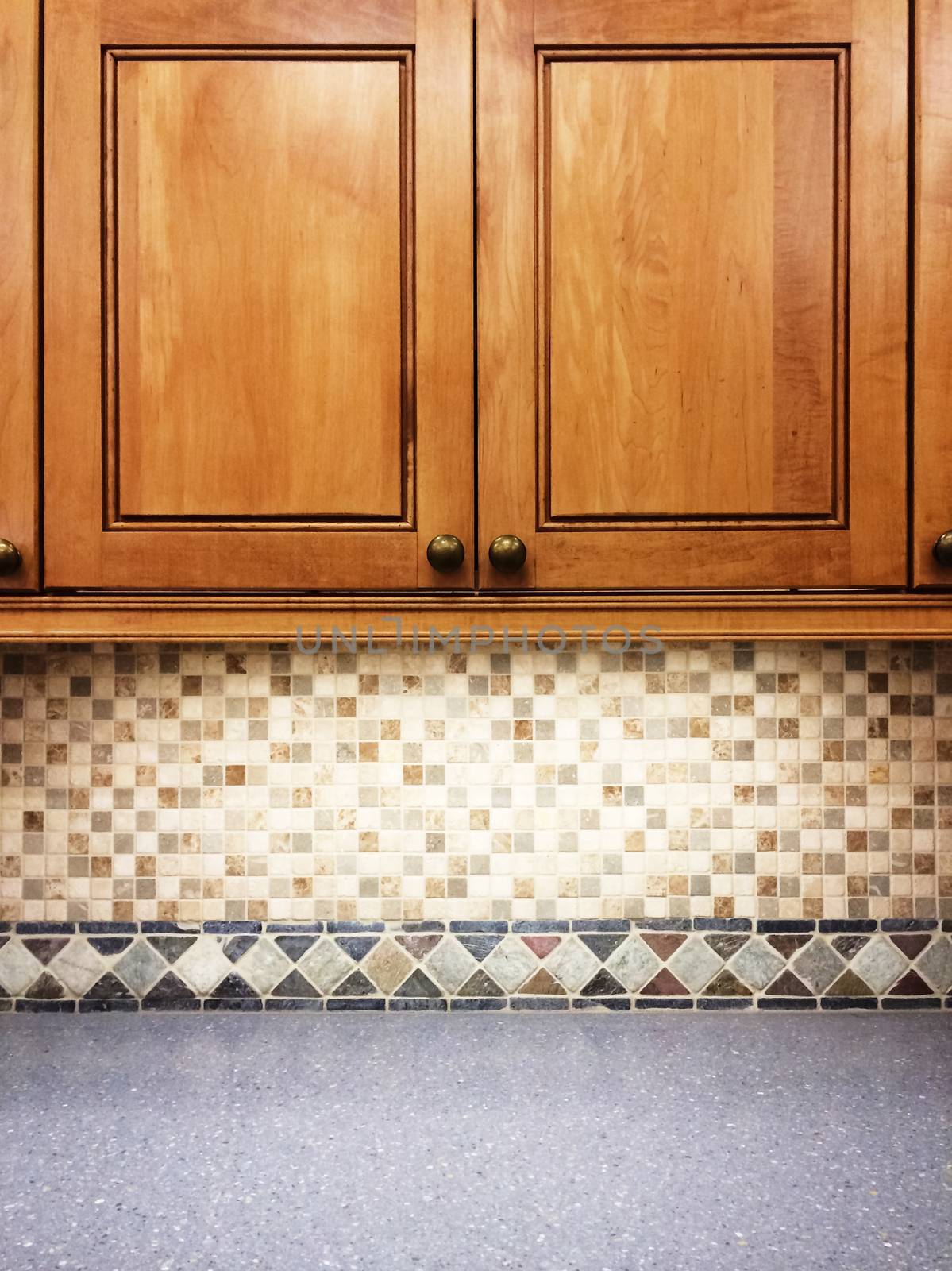 Kitchen with traditional wooden cabinets and tile decor.