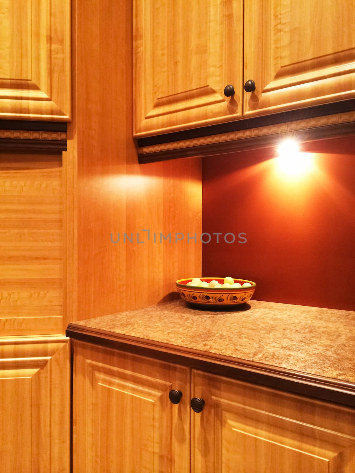 Kitchen with traditional design, in warm orange and red colors.