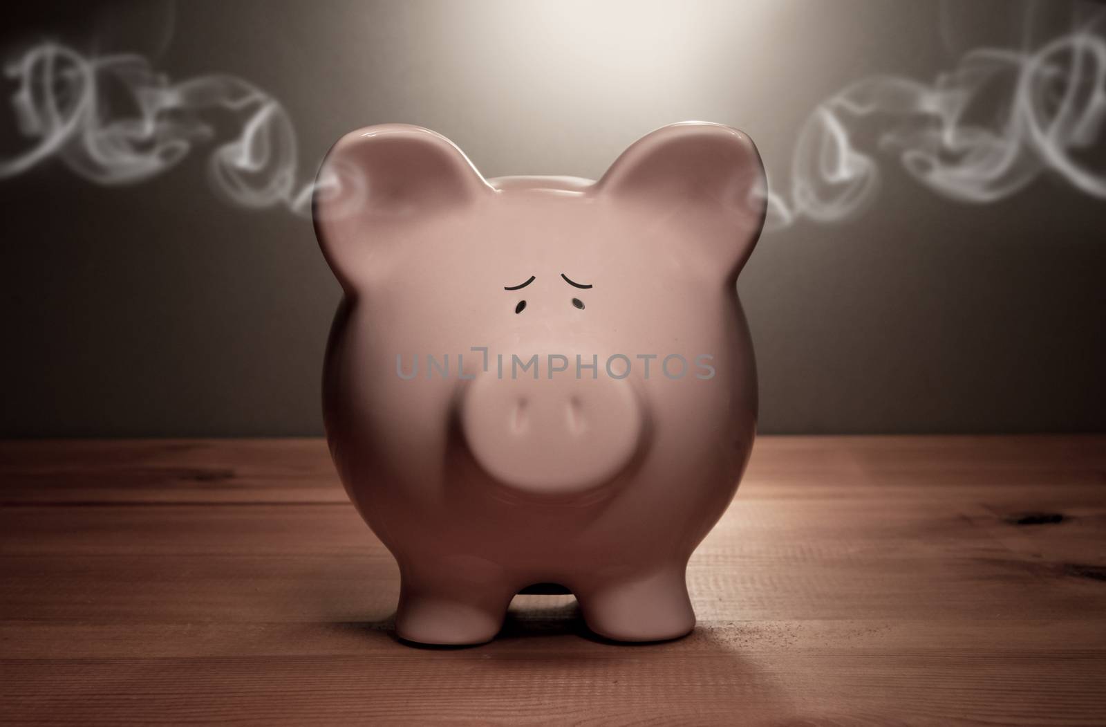 Piggy bank with smoke coming out of its ears
