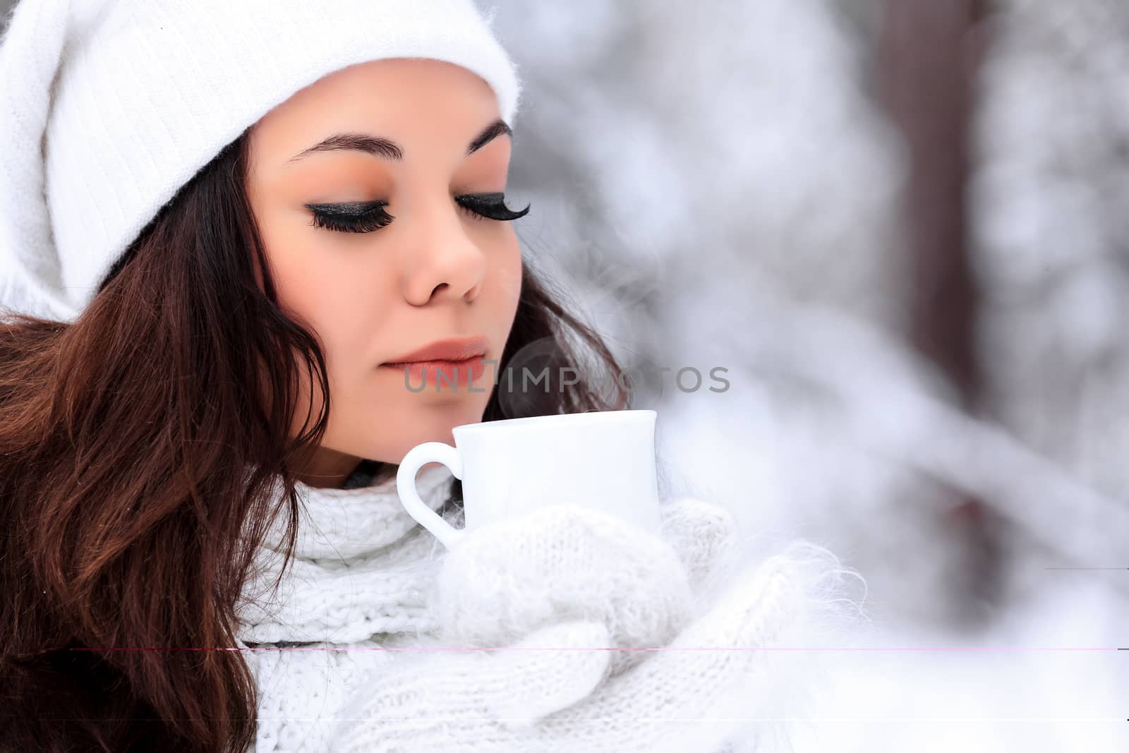 woman with a cup of hot tea posing outdoors