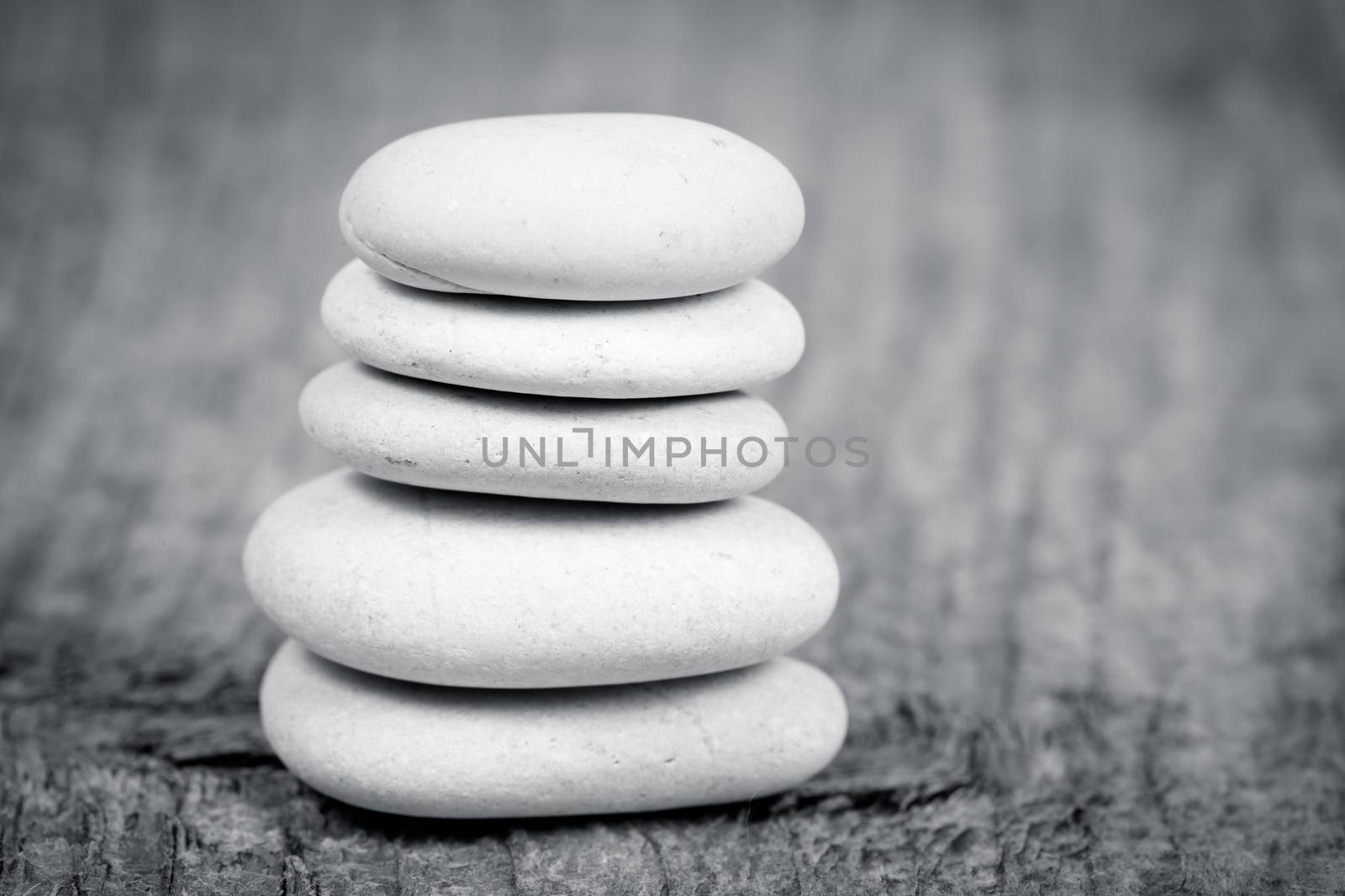 Pyramid of zen stones on a wooden board