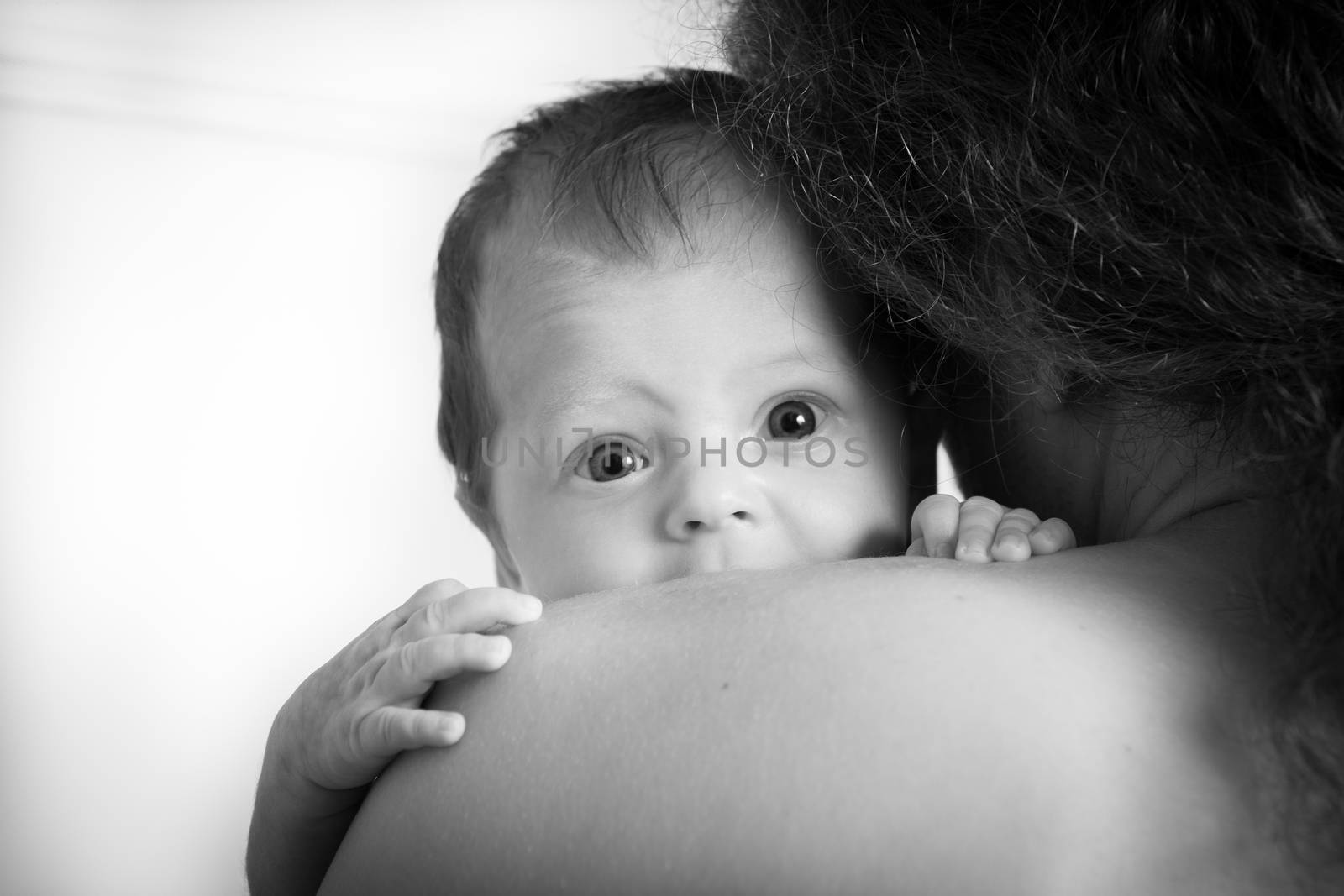 Black and white photo of a father holding his baby girl