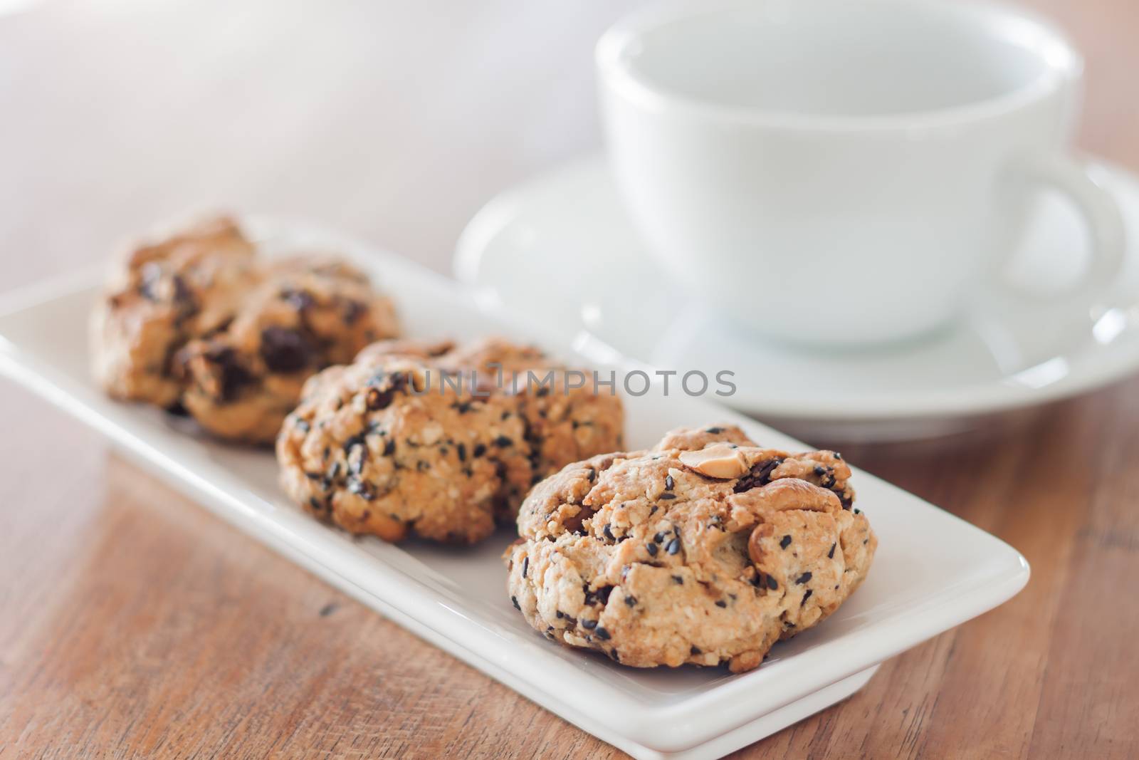 Closeup cereal cookies with coffee cup by punsayaporn