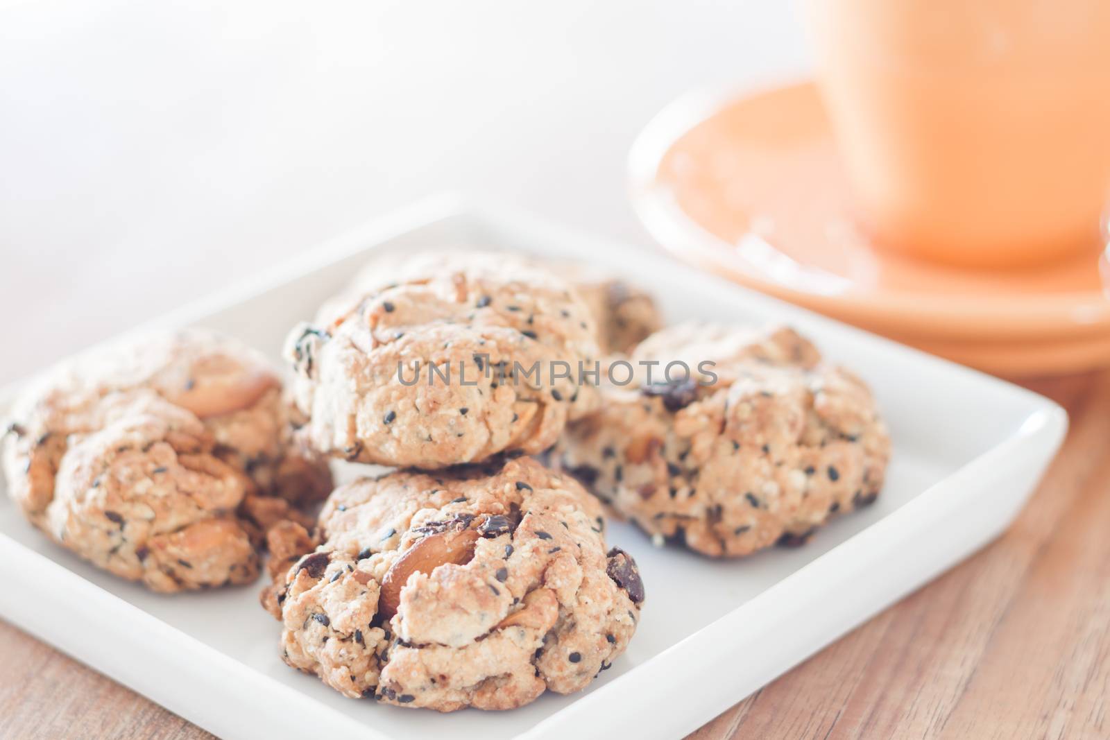 Closeup healthy cookies on white plate with coffee cup, stock photo