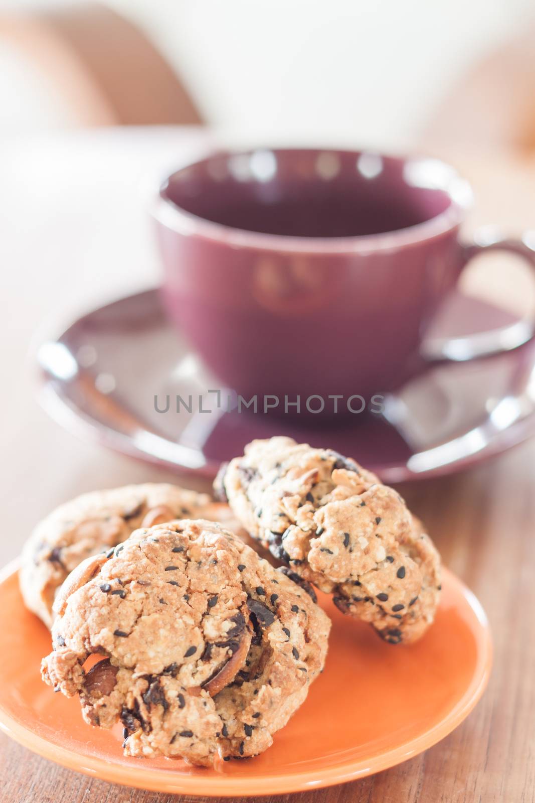 Closeup cereal cookies on orange plate, stock photo