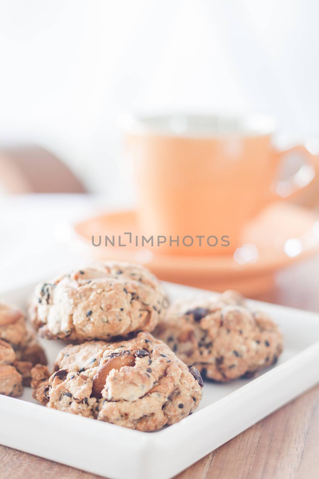 Healthy cookies on white plate with coffee cup by punsayaporn