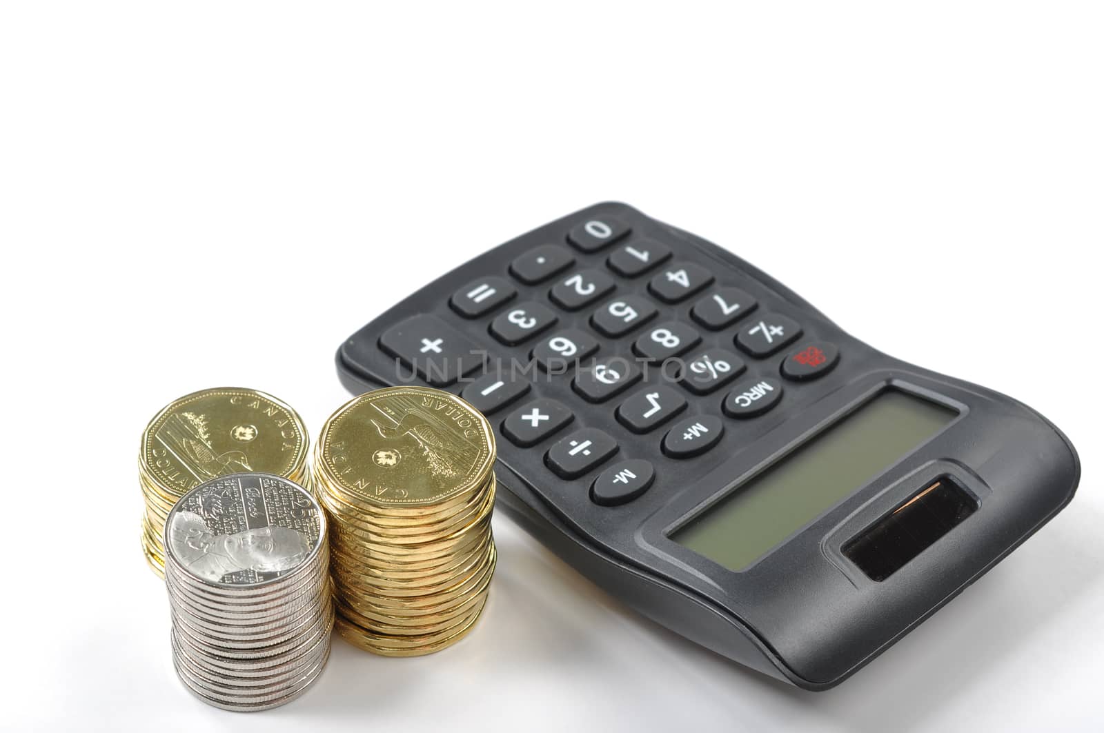 A calculator and money isolated on a white background 