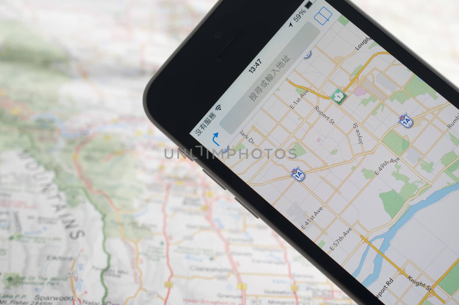 Smartphone with GPS navigator on map 