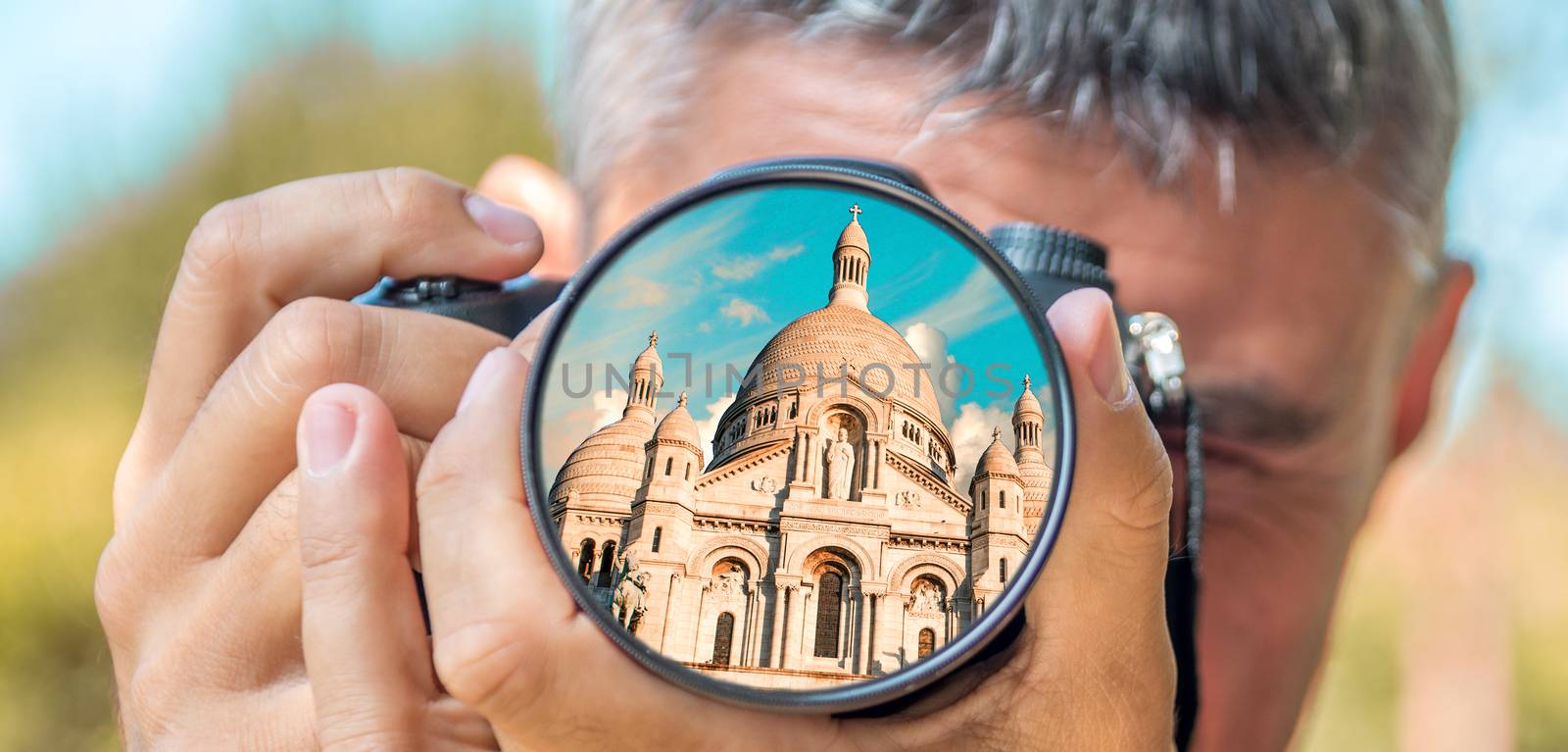 Photographer taking photo with DSLR camera at Sacred Heart Cathedral in Paris. Shallow DOF