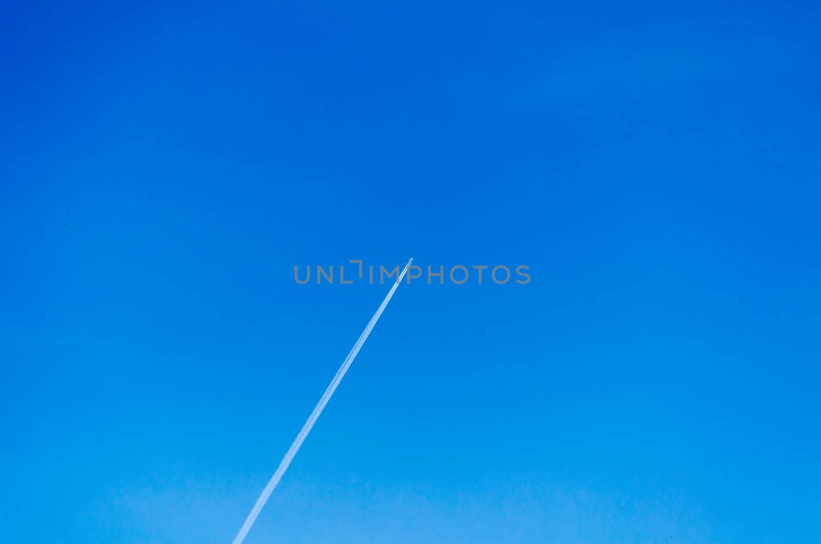 Aircraft leaving contrails in a cloudless sky.