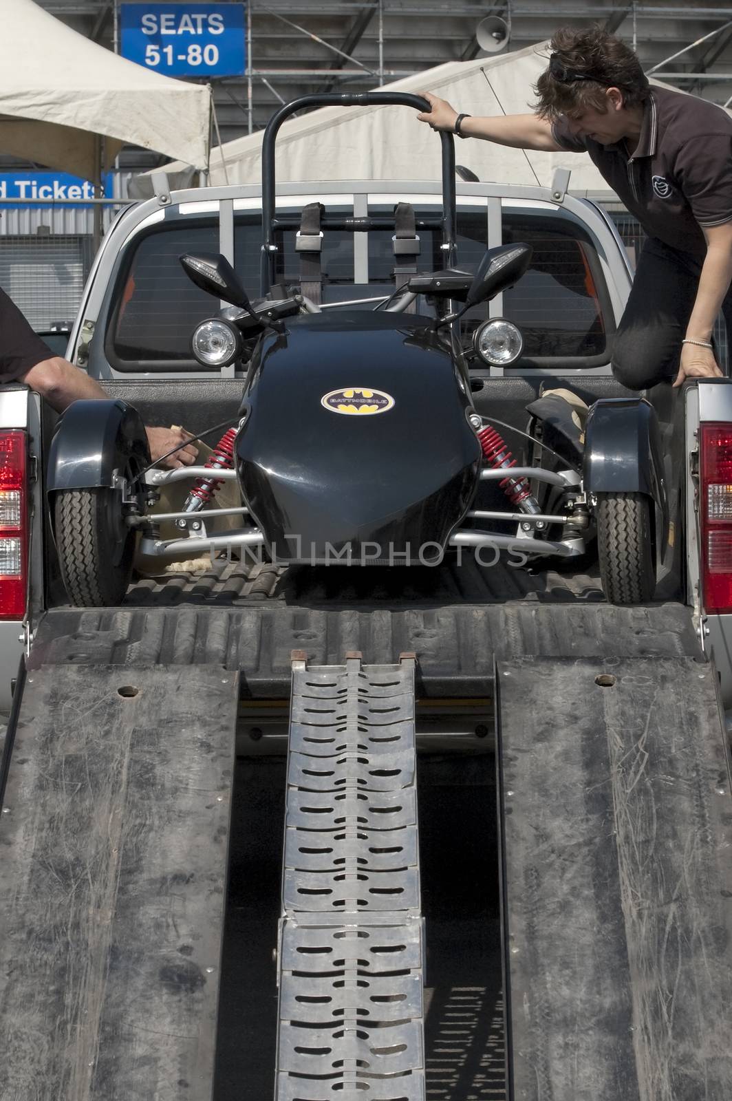 Santa Pod, UK - April 23, 2010: Alternative energy racing at Santa Pod Raceway. Battmobile electric trike being unloaded before racing.