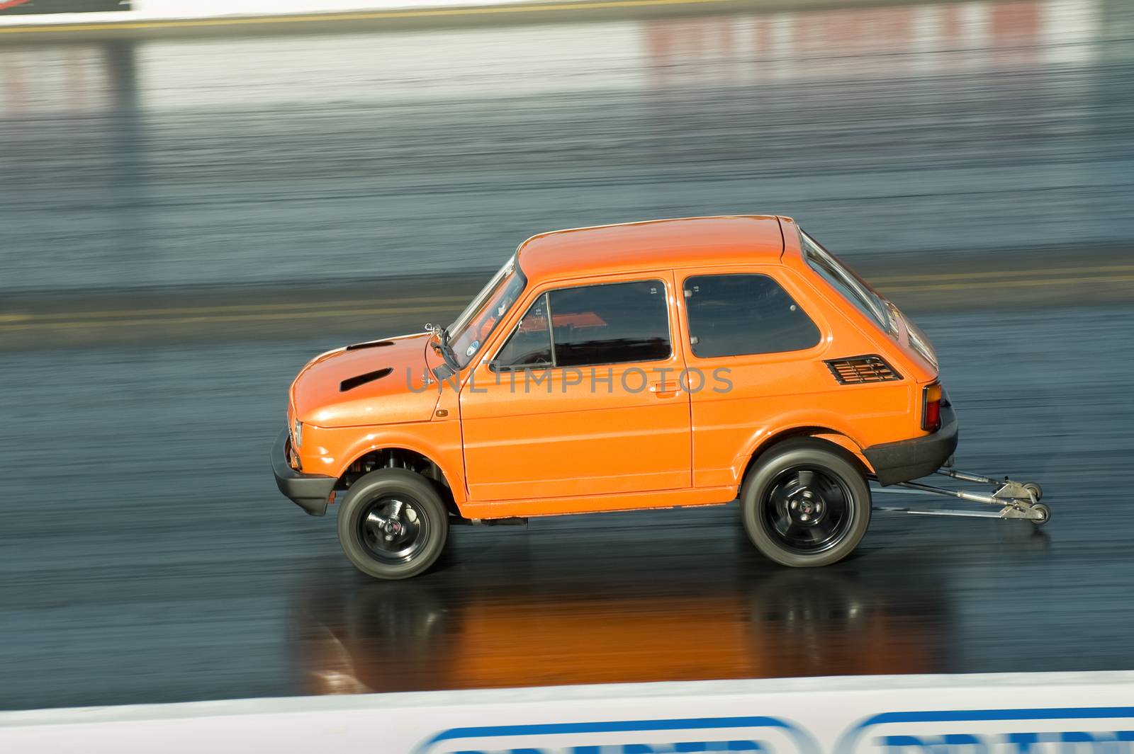 Santa Pod, UK - October 29, 2011: Modified small Fiat dragster on the quarter mile strip during the Flame and Thunder racing event at Santa Pod Raceway, UK